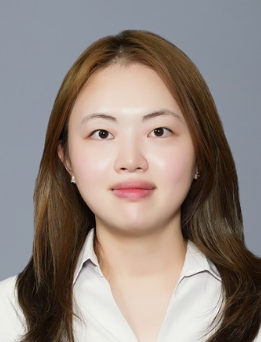 Picture of a professional woman with brown hair and wearing a white blouse.