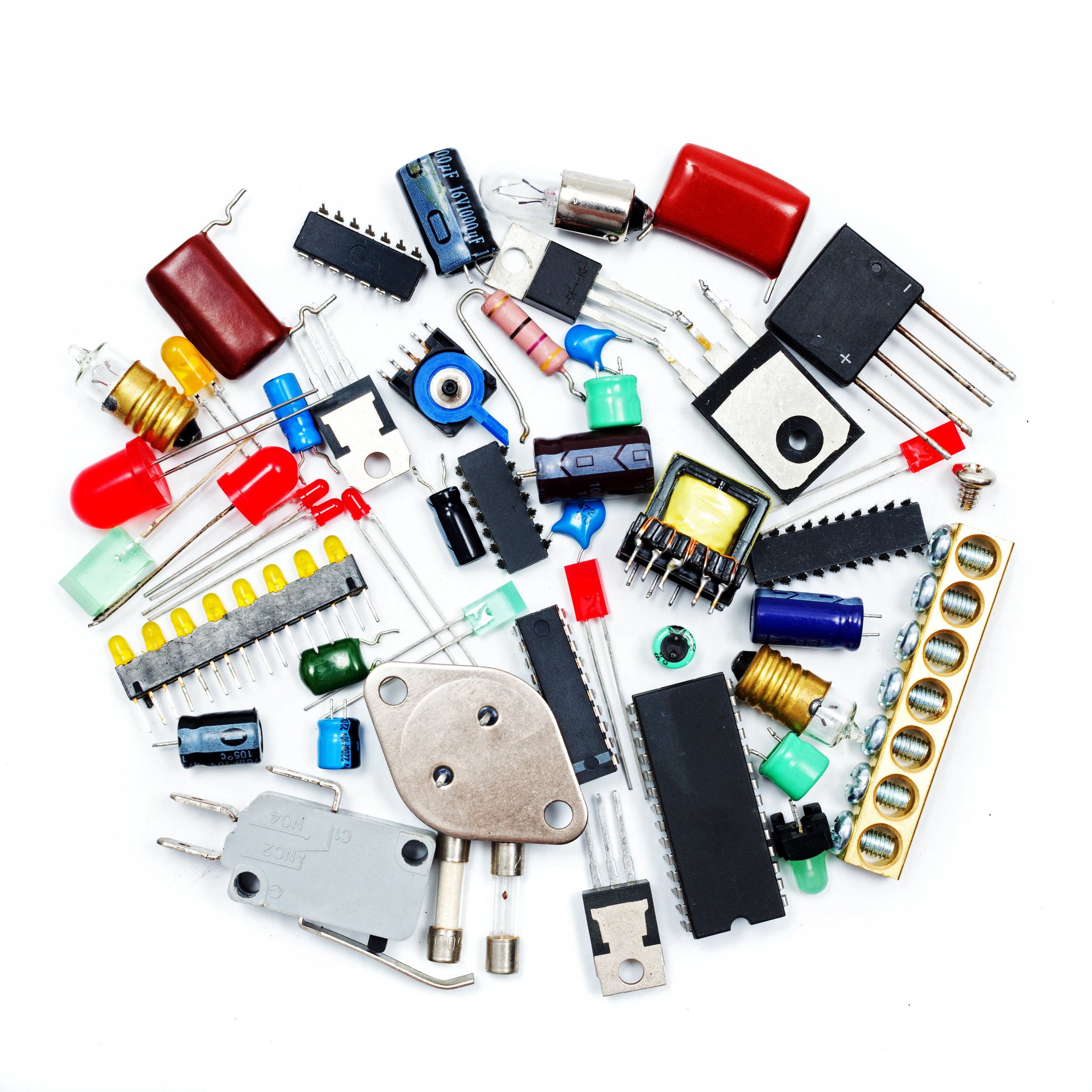 Assorted discrete electronic components, like LEDs, resistors, capacitors, light bulbs, and microchips
