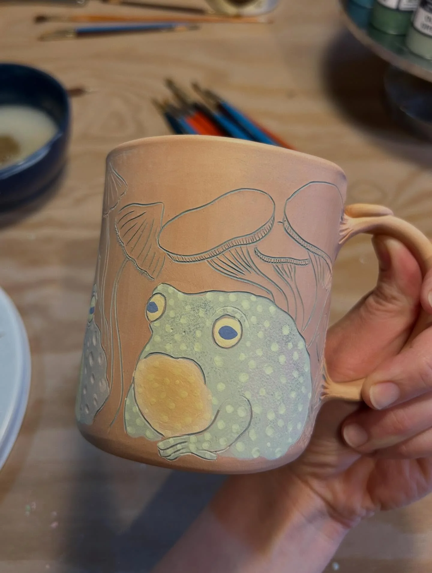 Scenes from the pottery studio &mdash; some in-progress frog/toad/mushroom mugs, some other mugs &amp; cups awaiting handle/interior glaze, wee bowls, and more toadhats! Basically, I&rsquo;m chugging along with prep for my next @613flea on March 21st
