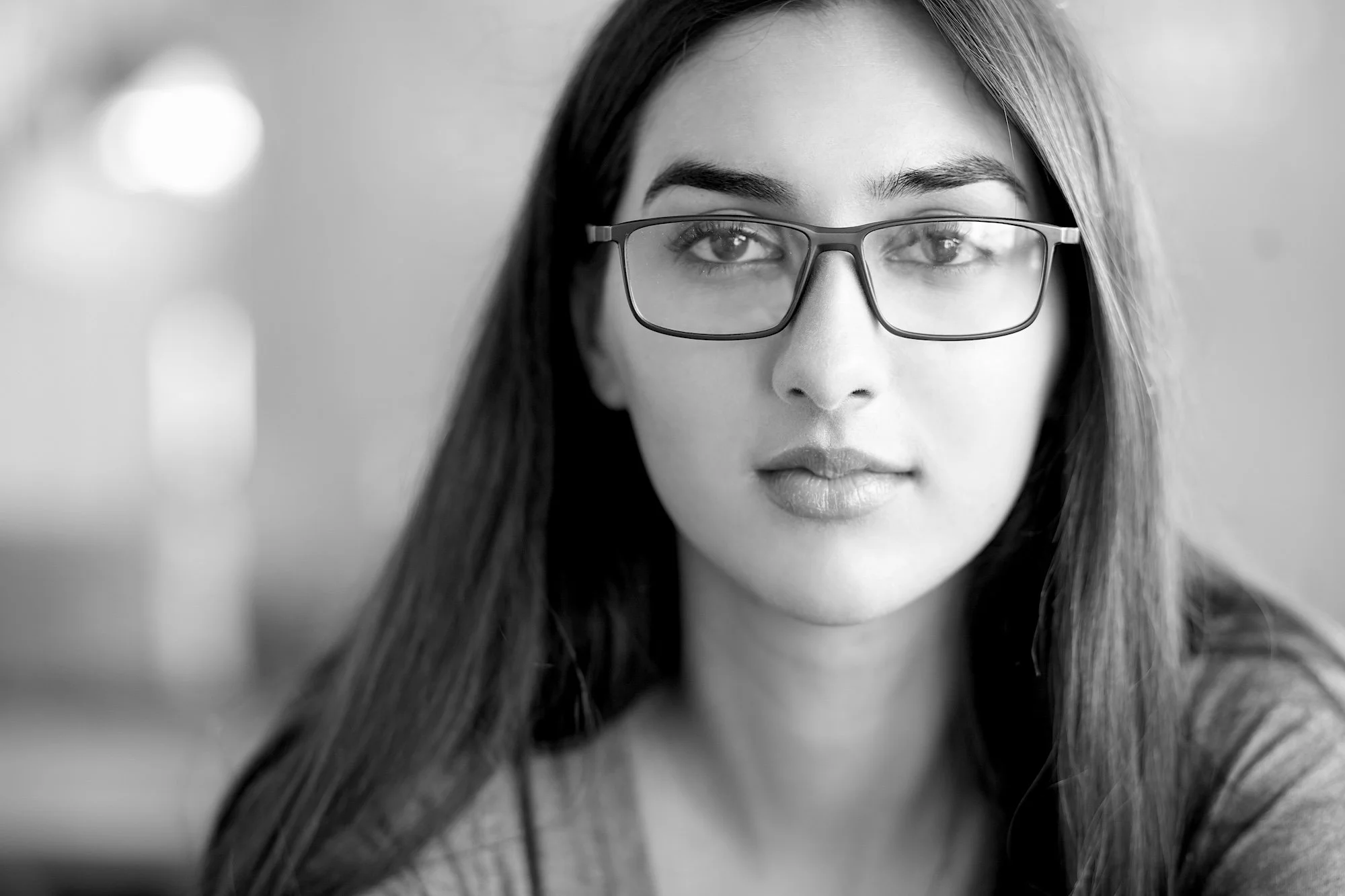A young female aspiring board member wearing glasses.