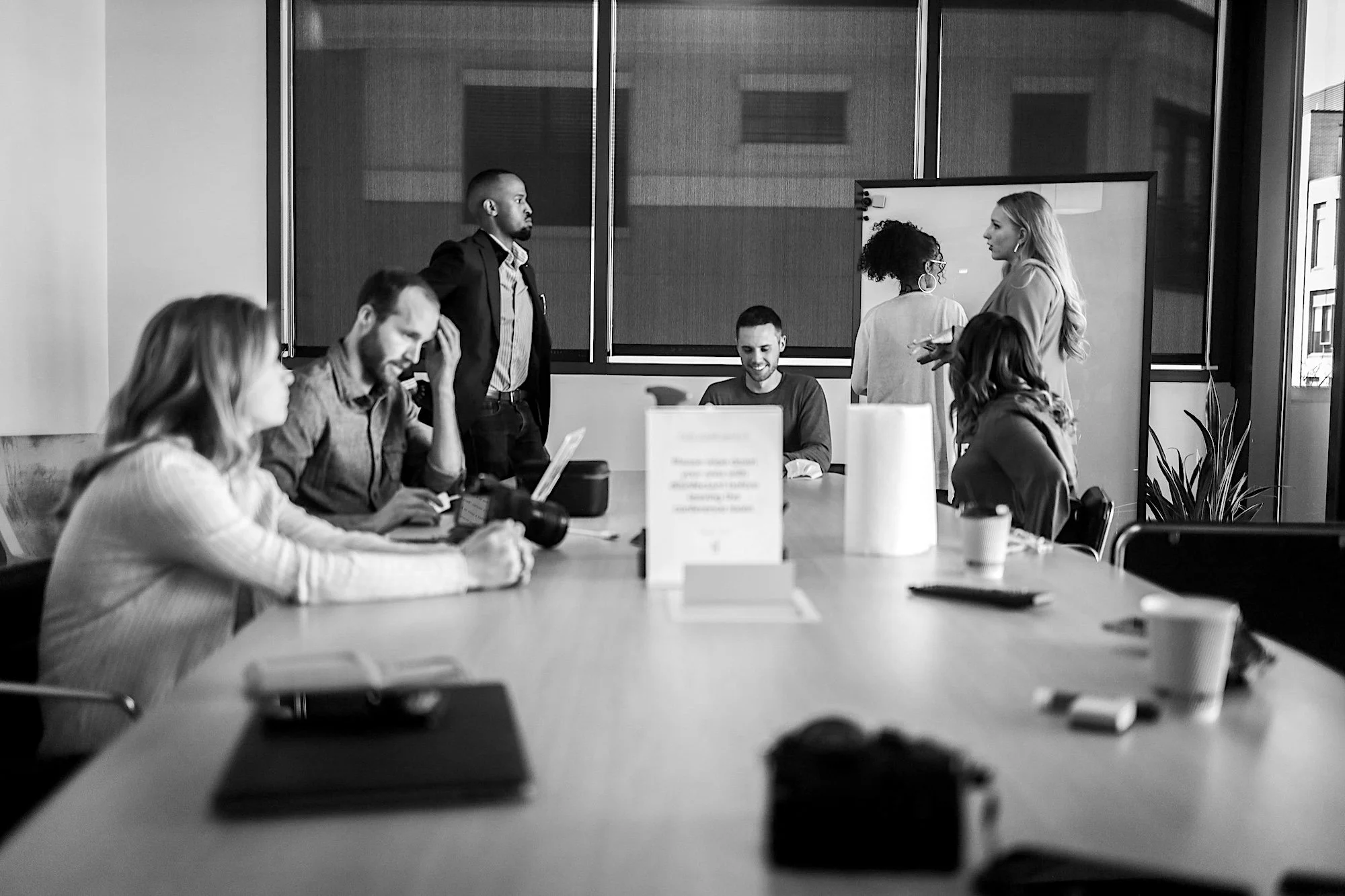 A group of business people discussing executive search and recruitment around a table.