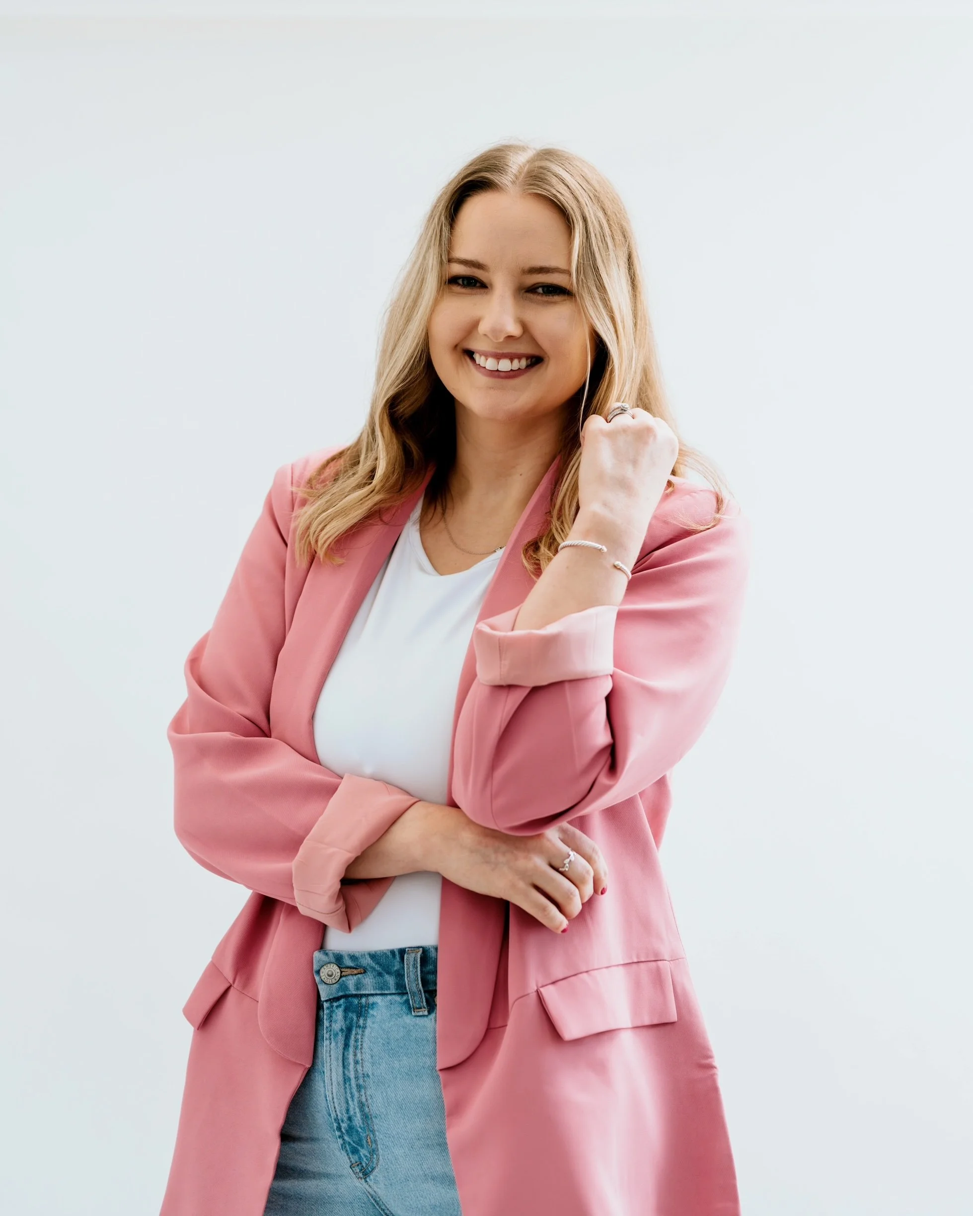 Dr. Victoria Williams smiling in a pink blazer, offering individual therapy for adults in Tennessee.