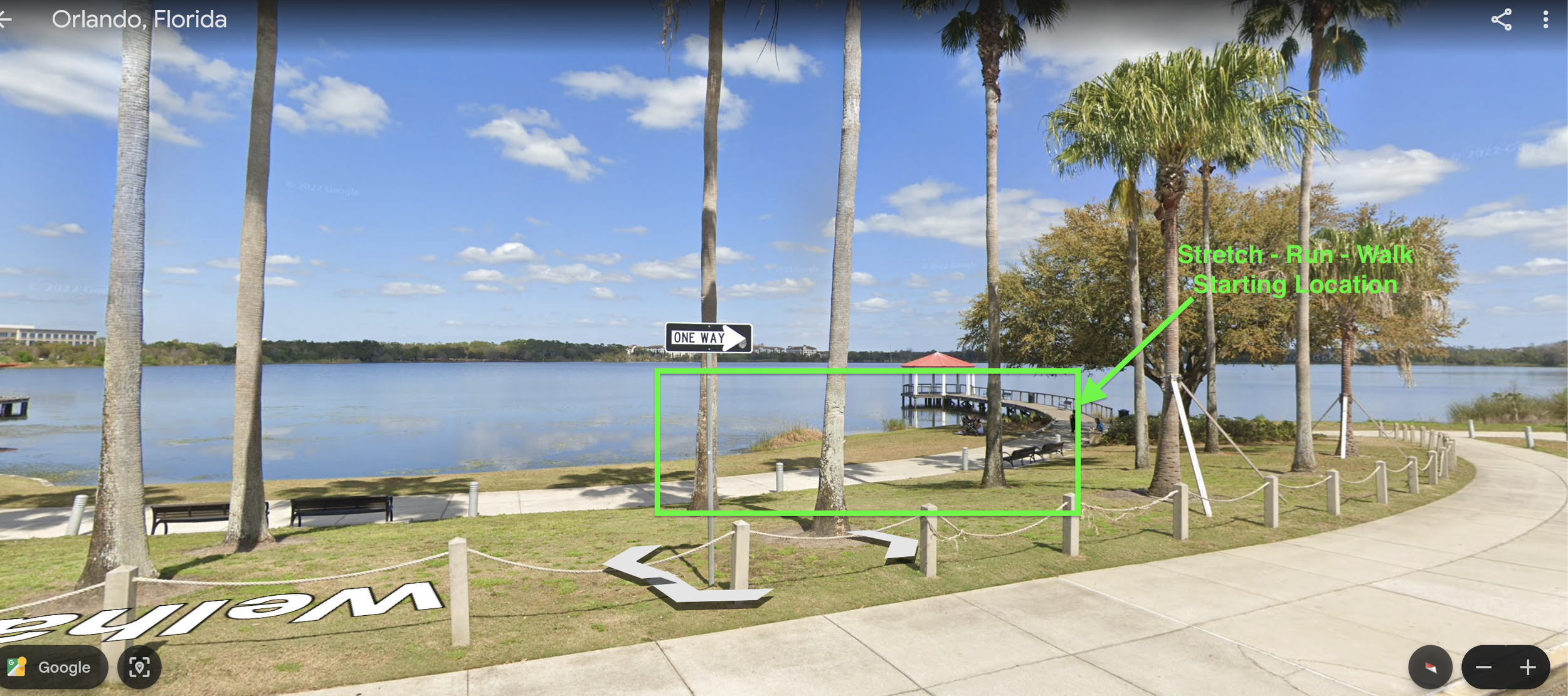 Scenic view of a lakeside park in Orlando, Florida with palm trees, benches, a walkway, and a gazebo in the background. Overlaid text indicates a stretch running starting point near a tree.