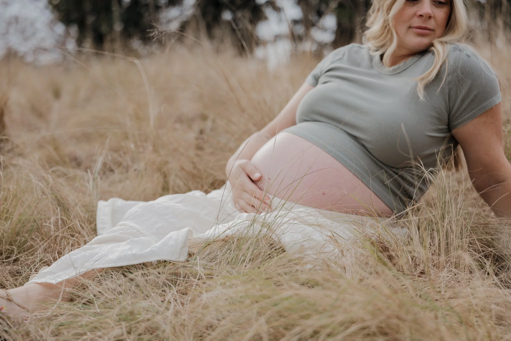Maternity photos in Raleigh, North Carolina, taken at NCMA Park with a focus on natural movement and emotional storytelling.