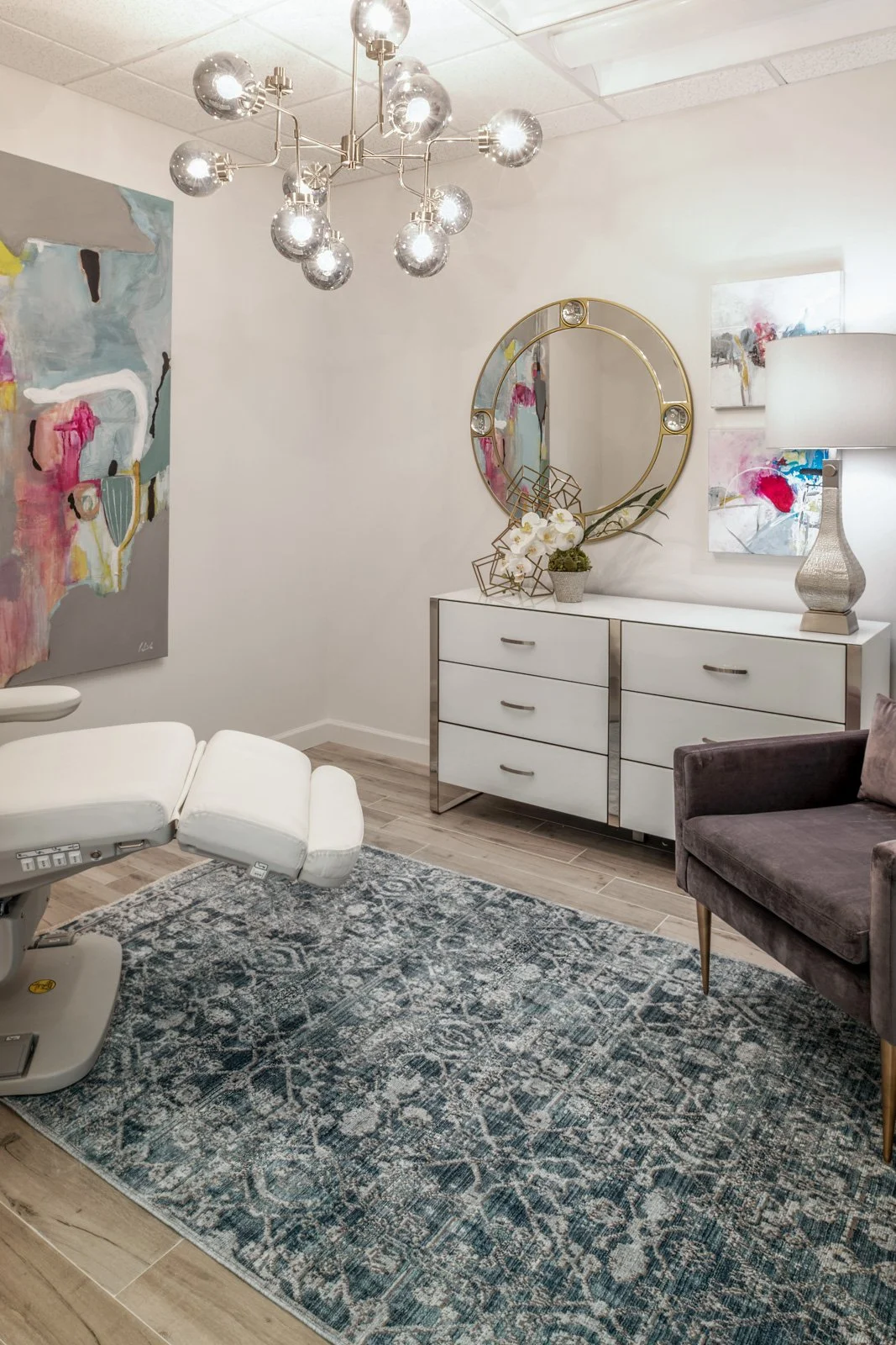 Medical practice patient room interior designed by The Design Firm, featuring comfortable seating, contemporary furnishings, elegant lighting, and a welcoming environment for patients.