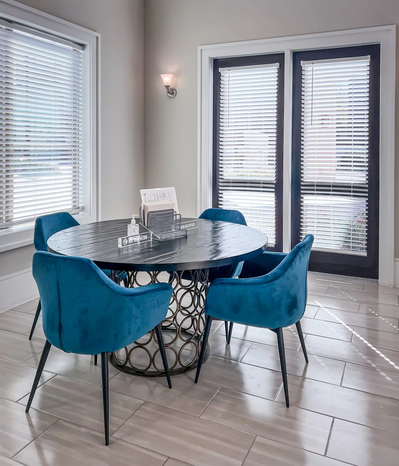 Commercial design for this active senior living space dining area that is transitional with blue velvet chairs.