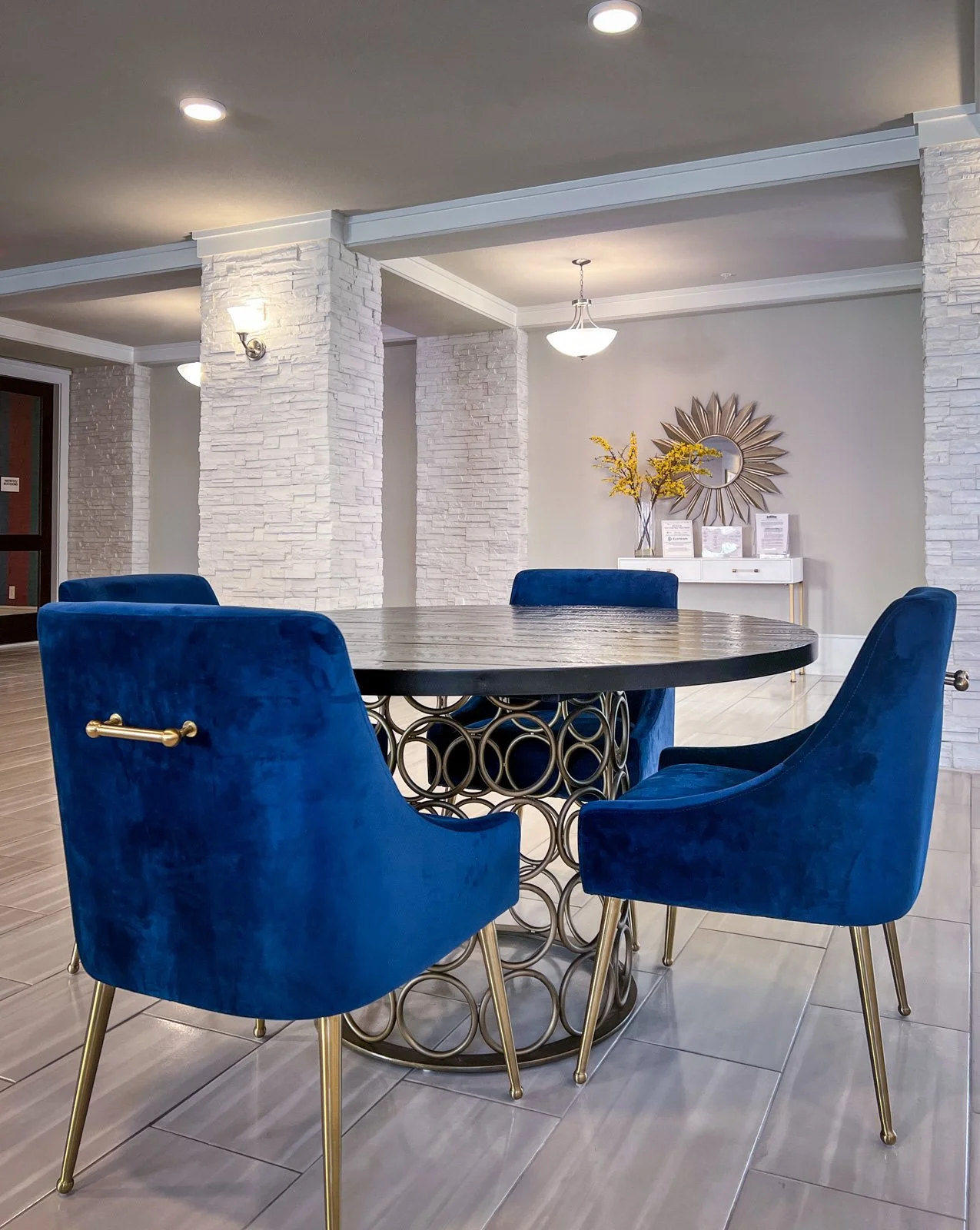 White walls in the commercial living space blue with gold accents.