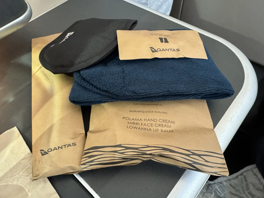   Amenity kit including hand and face cream, lip balm, dental kit, eye mask, socks and ear plugs.  