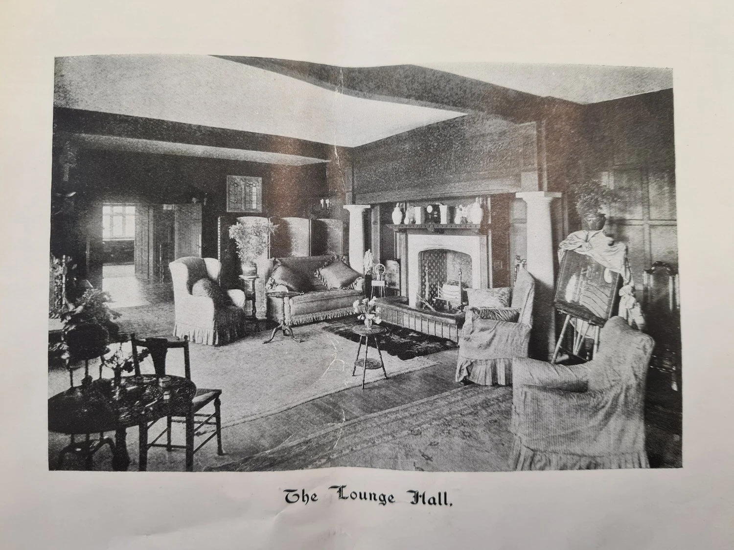Historic interior photograph of the Lounge Hall at Lanwades Hall with period furniture and fireplace.