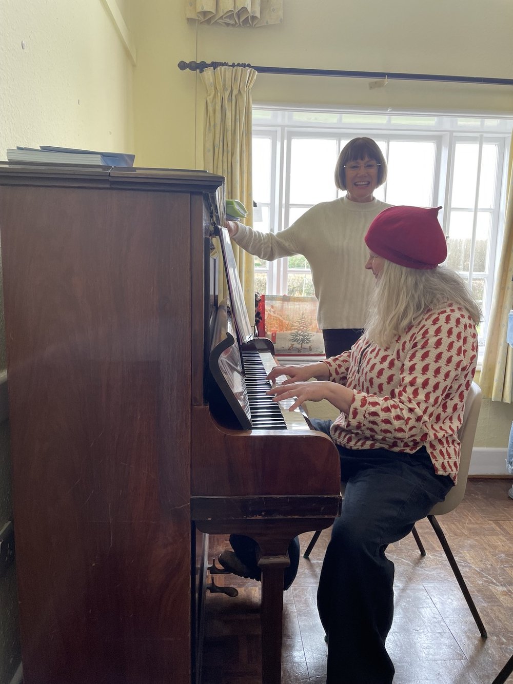 Kate plays the piano while everyone settles in