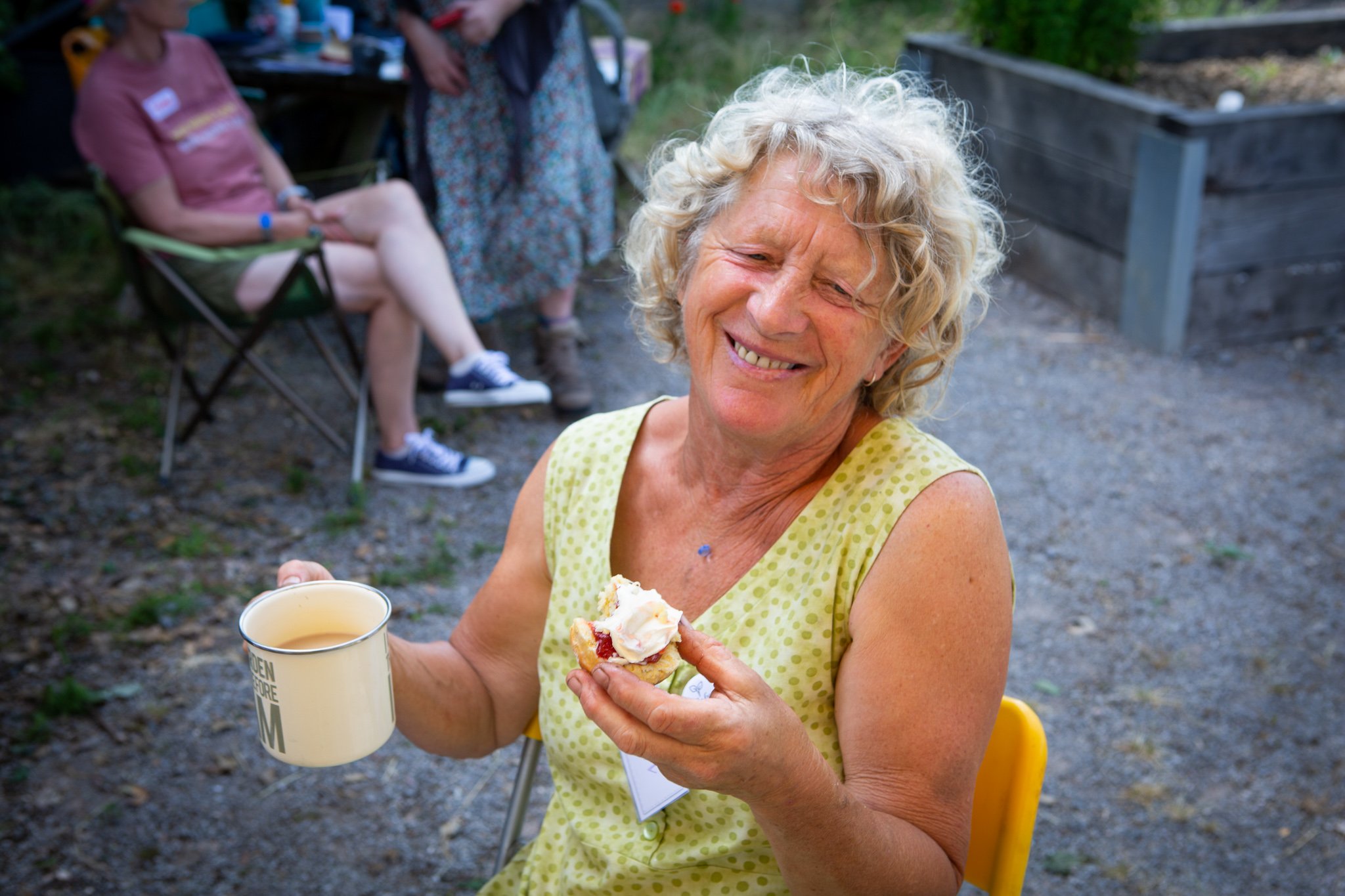 In Jolly Good Company - Cream Tea at the allotment - Anni enjoys a scone.jpg