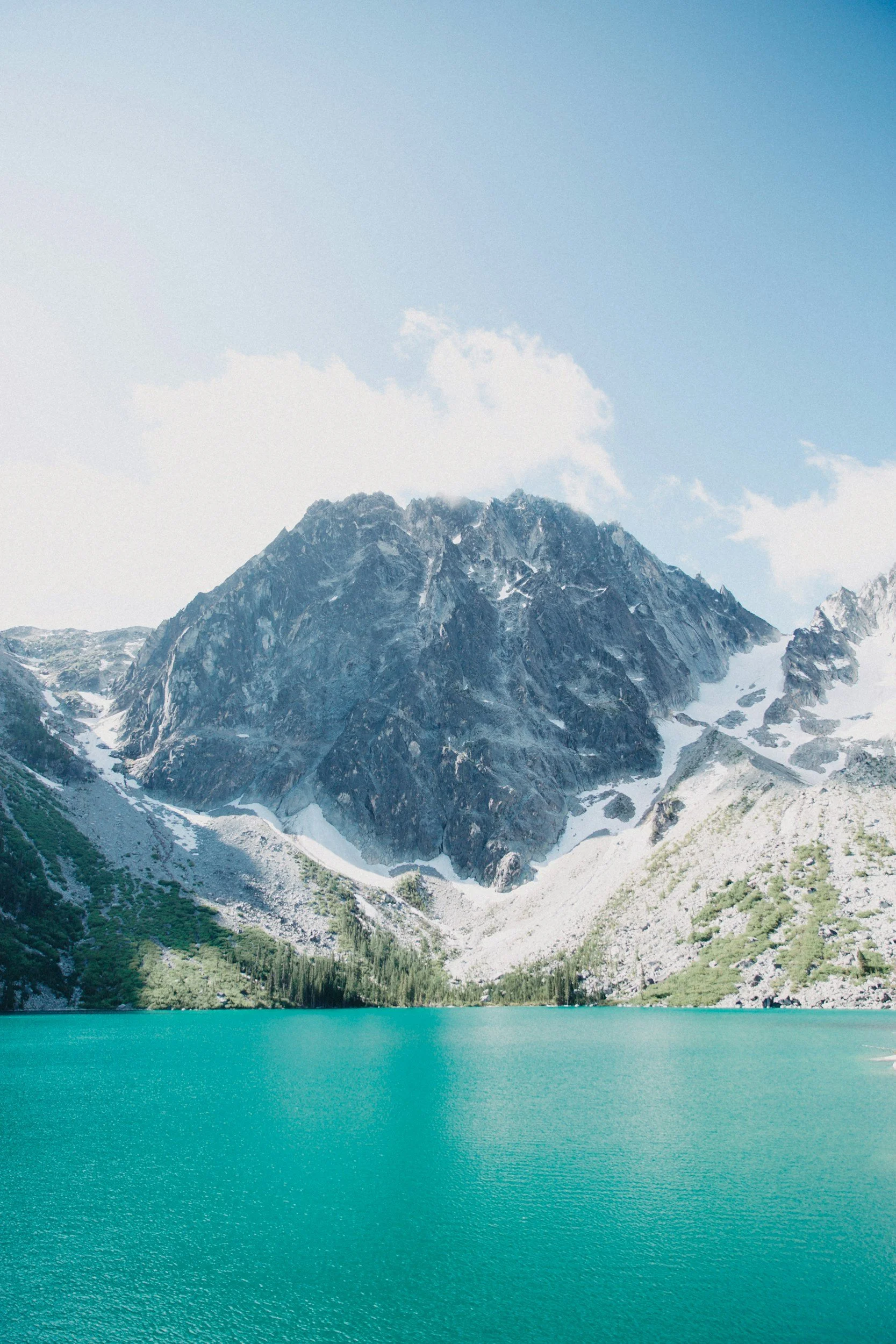 Clear blue water with a rocky mountain in the back