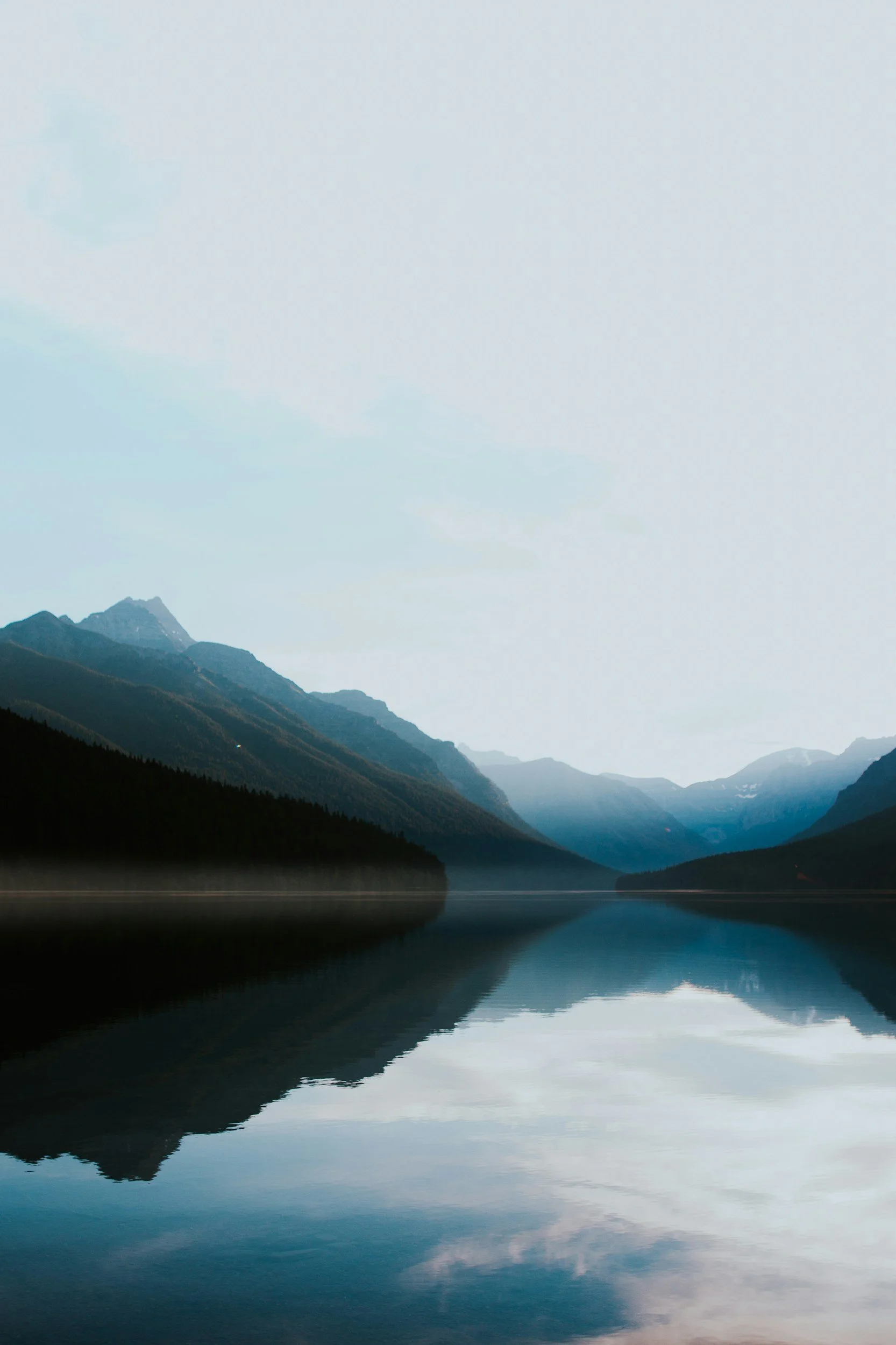 calm lake with rolling hills in the back