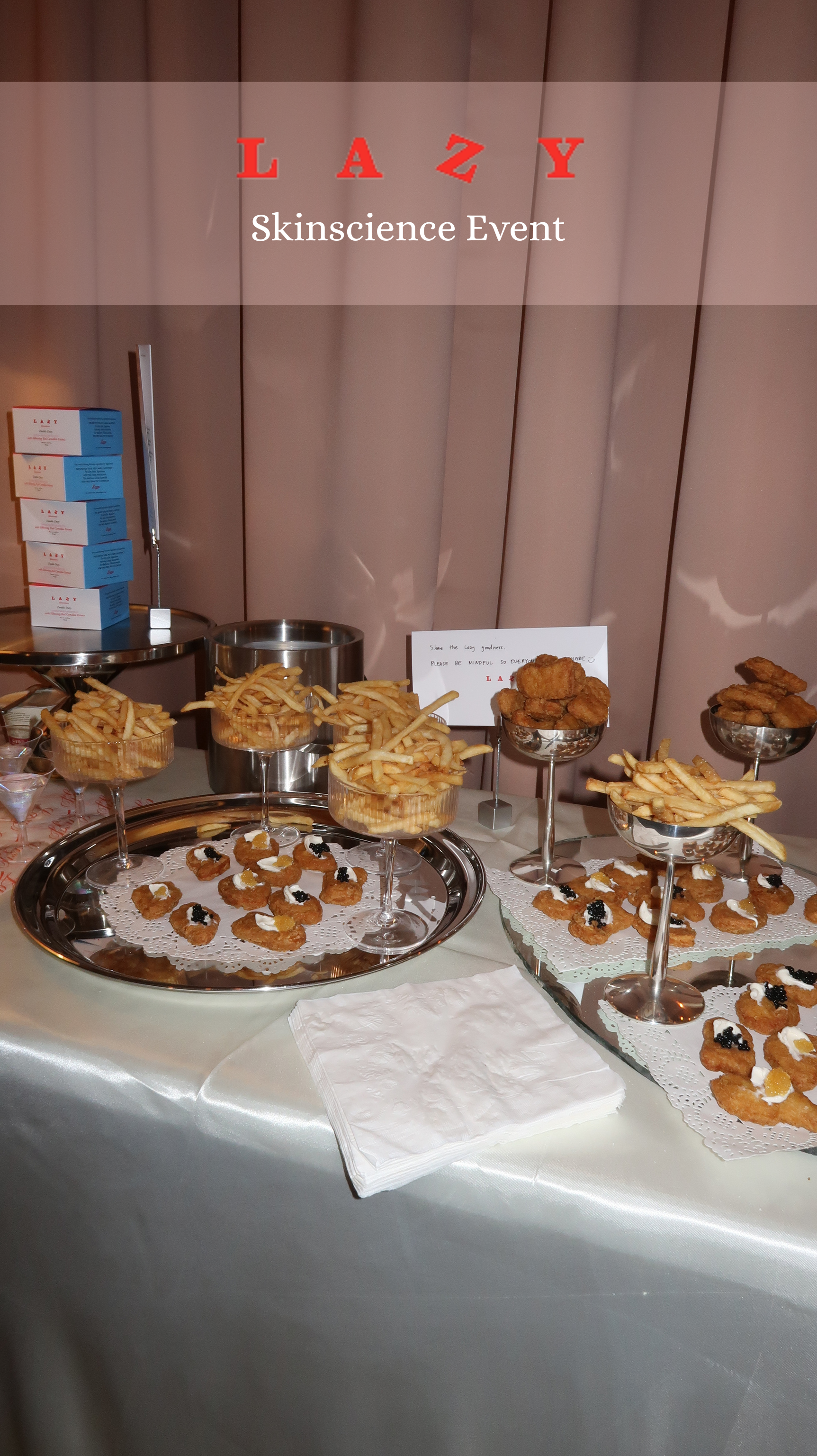 Lazy Skinscience food table spread with chicken nuggets topped with creme fresh and caviar and French fries.