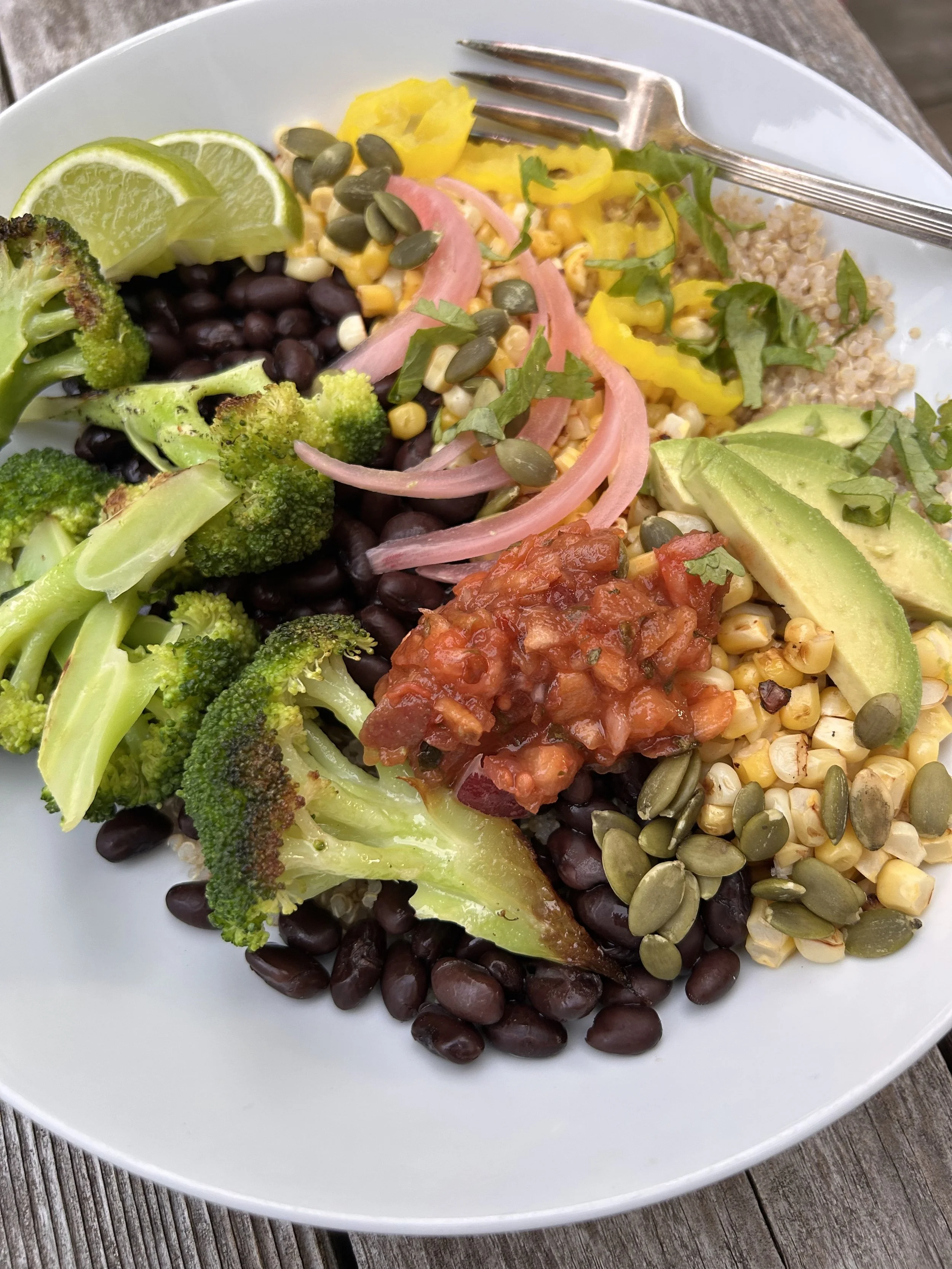 A meatless Mexican themed bowl with lots of veggies, grains and cheese!