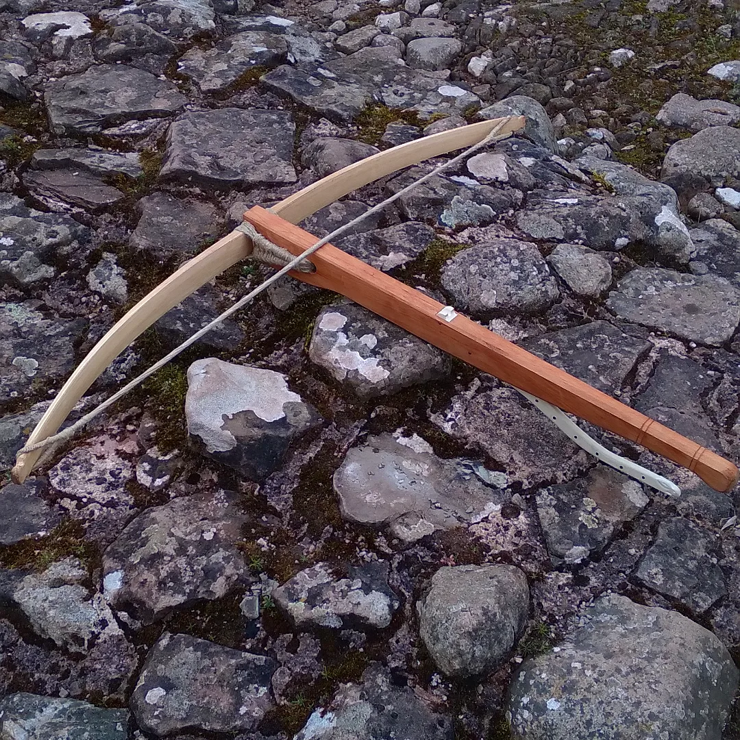 A 40lbs 12th century reeinactment crossbow. The 'hare' trigger is a of a fictional design based on a contemporary stone carving provided by the customer.