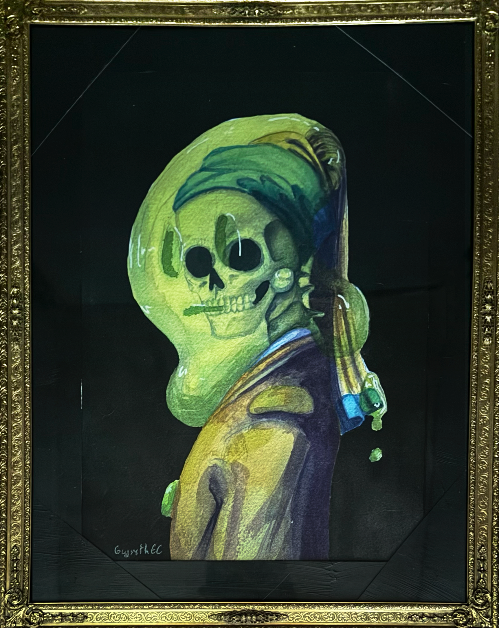 A colorful graffiti painting of a skeleton wearing a hoodie, with the skull partially covered by the hoodie, on a black background, framed in an ornate gold frame.