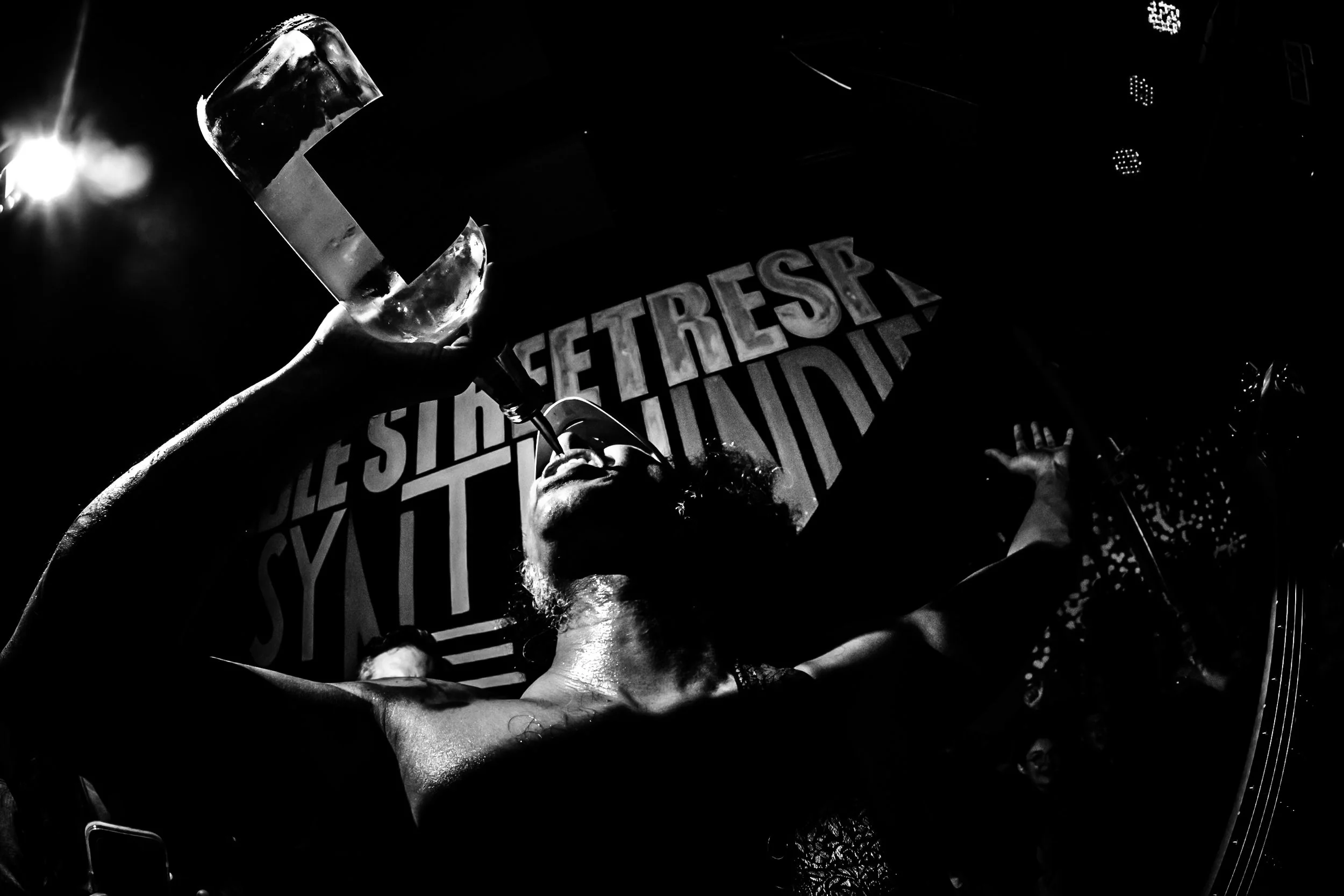 Taken during a 2025 performance by the band Daikaiju. A bartender waded through a  sea of people to hand a bottle of tequila to the lead guitarist of the band, who then proceeded to pour it into the mouths of everyone standing nearby and his own mout