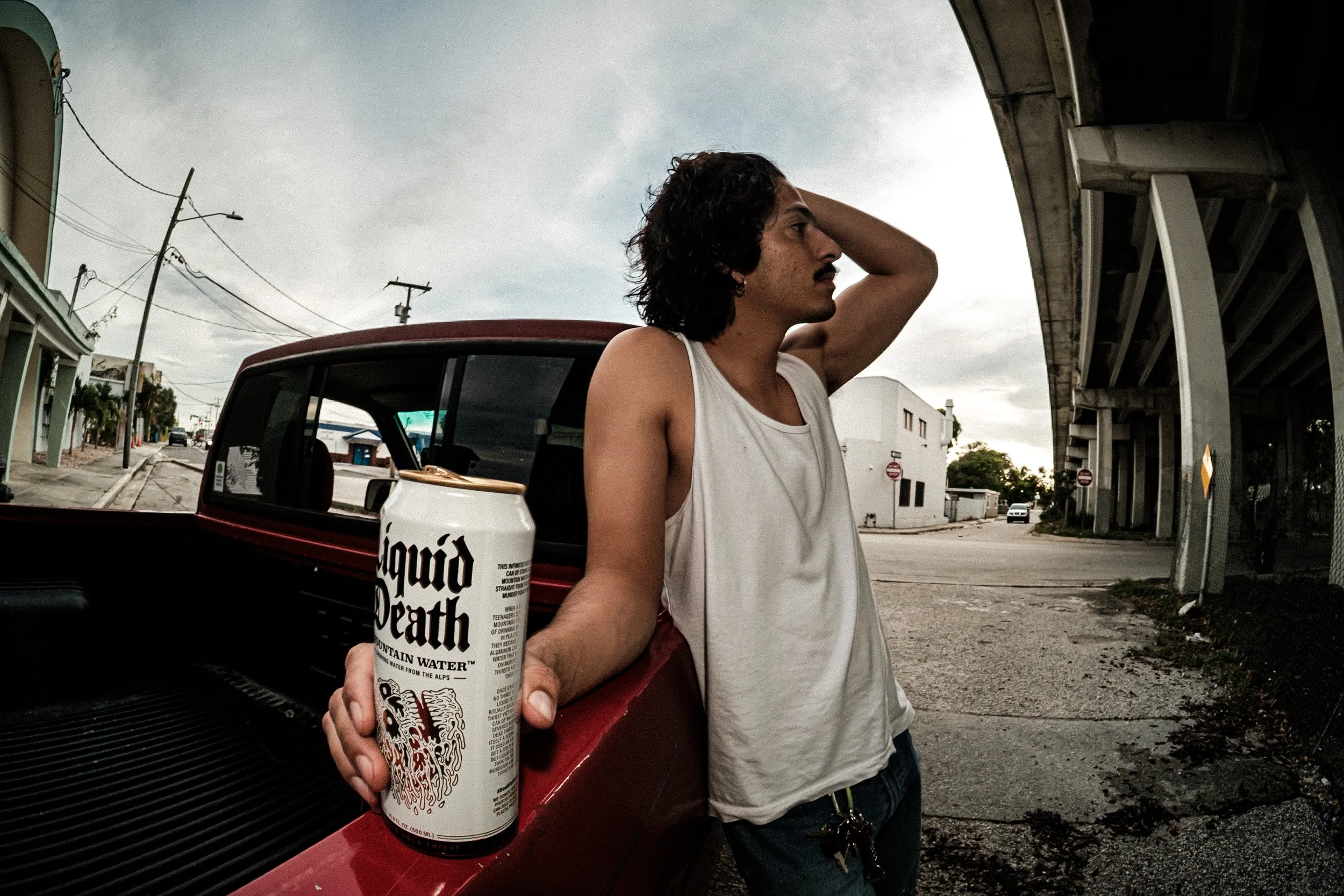 An acquaintance of mine, José, was an aspiring model, doing a shoot together I noticed he had several cases of Liquid Death in the cab of his truck. We decided to do some photos as if he "had too much to drink" and passed out in his truck bed. 

Abou
