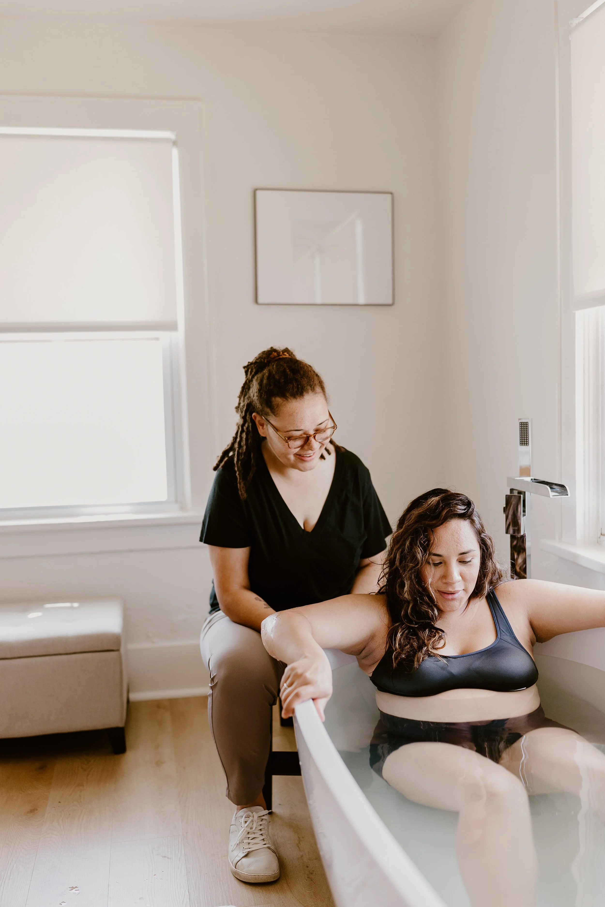Brianna supporting a pregnant woman for a water birth at the OKC Birth Center