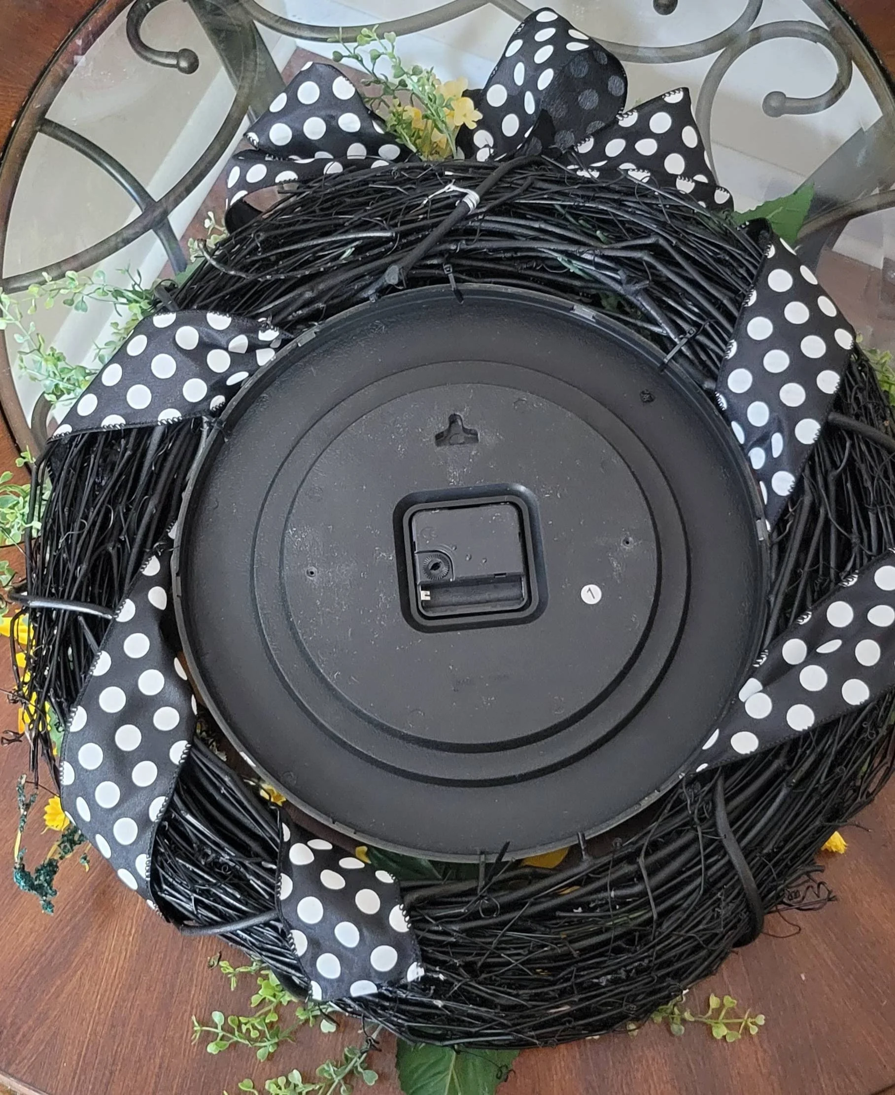 Back of sunflower grapevine clock wreath showing clock mechanism