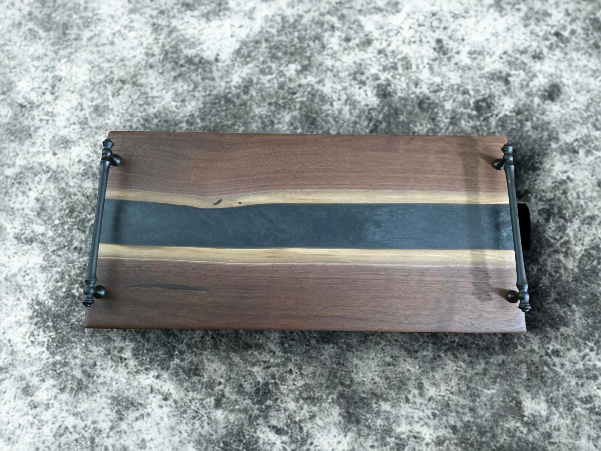 black walnut charcuterie board with black handles.jpg