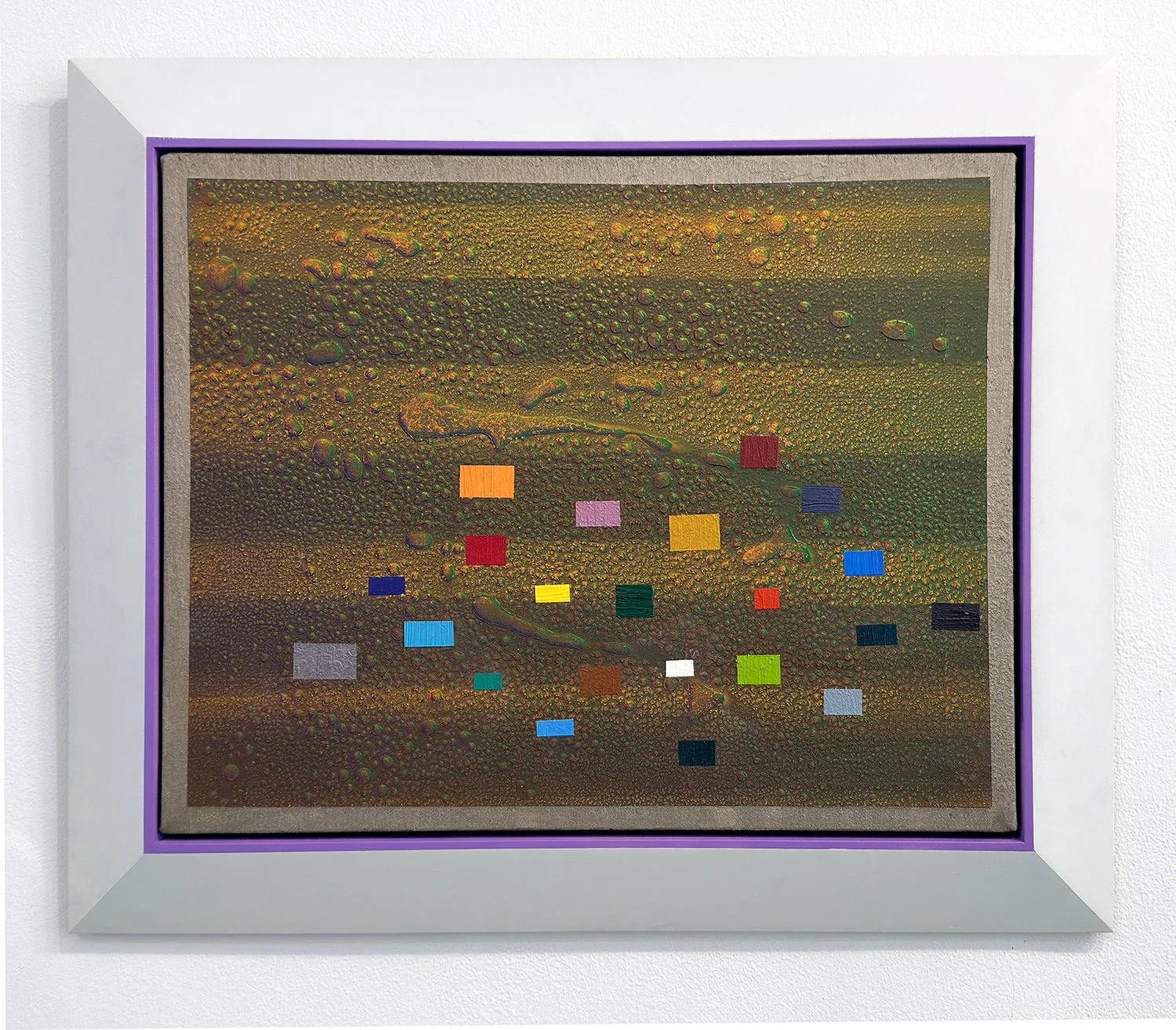 A framed abstract artwork with a textured background of paint textures and colorful rectangular shapes.