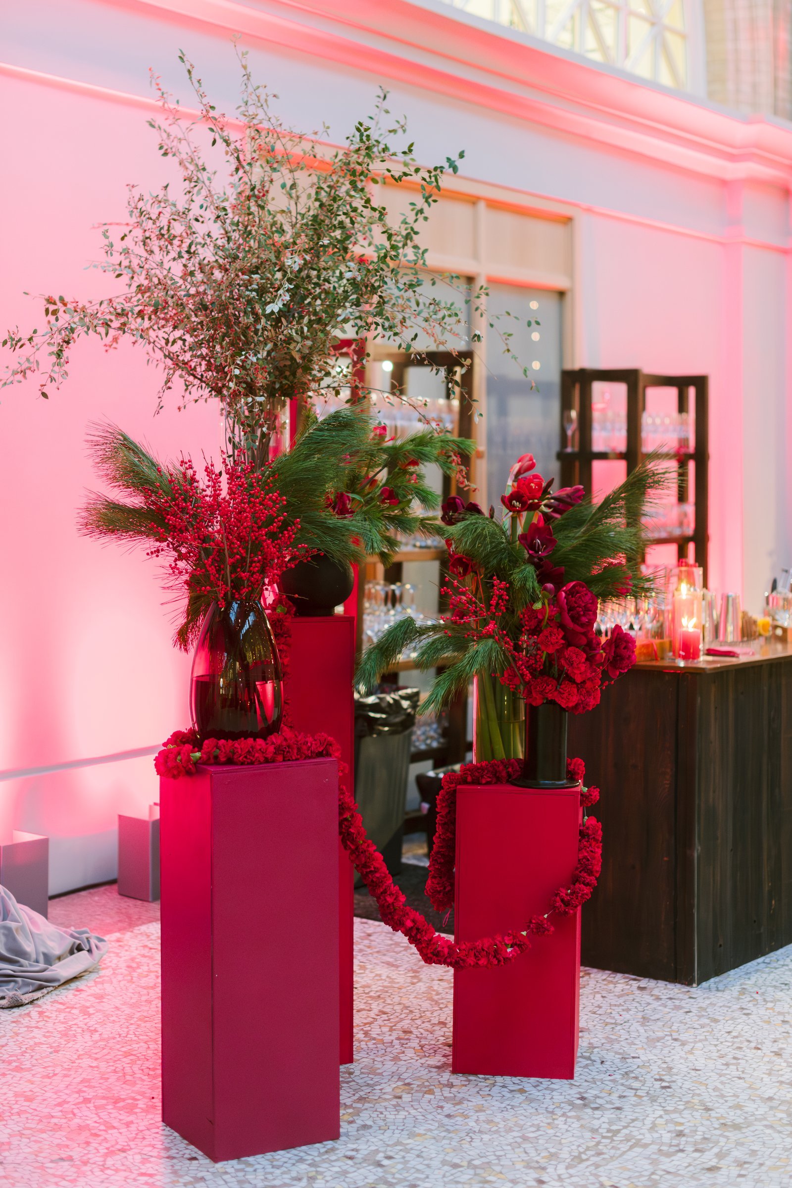 bay-area-corporate-holiday-party-red-pedestal-floral-installation-carnation-garland-winter-berries-pine-holiday-bar-san-francisco.jpg