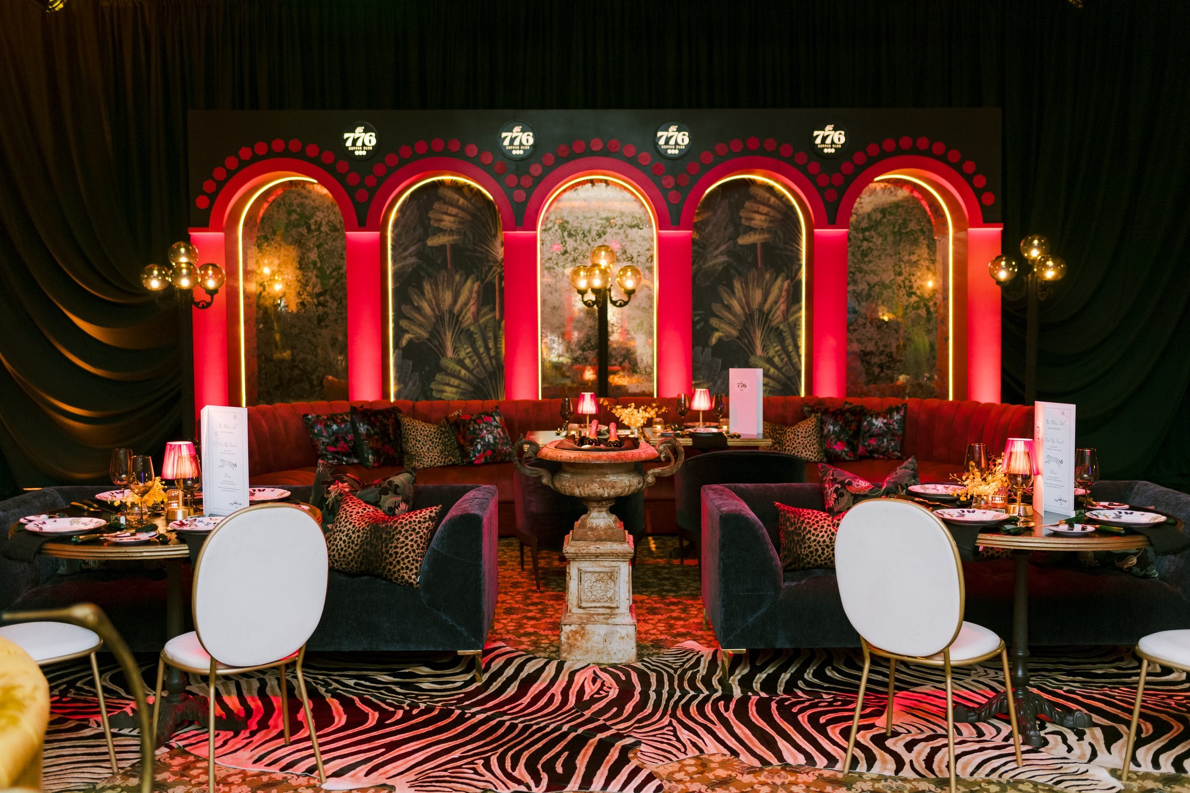 bash-please-utah-investor-community-summit-the-776-supper-club-immersive-dinner-design-arched-backdrop-zebra-rug-velvet-banquette.jpg