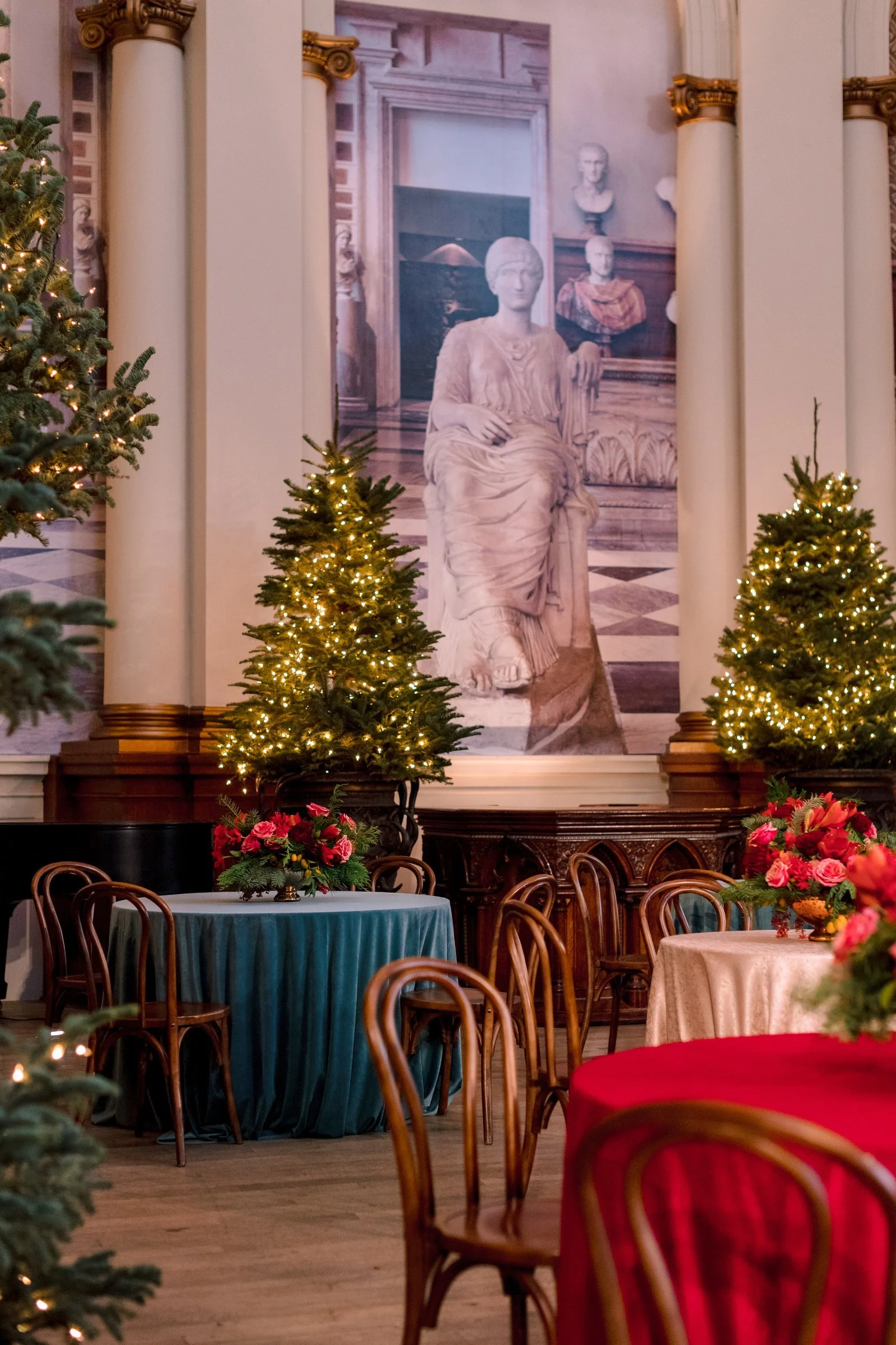 bay-area-corporate-holiday-party-rotunda-holiday-party-san-francisco-classical-statue-mural-backdrop-lit-evergreen-trees-velvet-linens.jpg