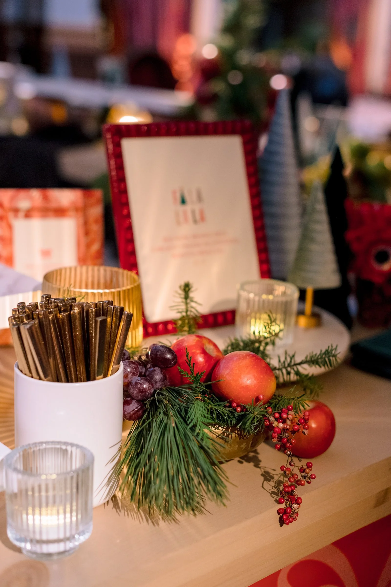 bay-area-corporate-holiday-party-holiday-buffet-styling-fa-la-la-printed-menu-red-frame-apples-pine-berry-garnish-corporate-event-design.jpg
