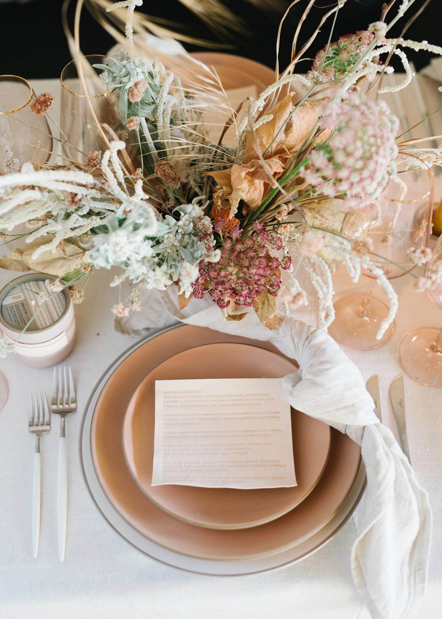 norman-and-blake-launch-gathering-los-angeles-overhead-place-setting-blush-stoneware-embossed-leather-menu-dried-wildflower-centerpiece.jpg
