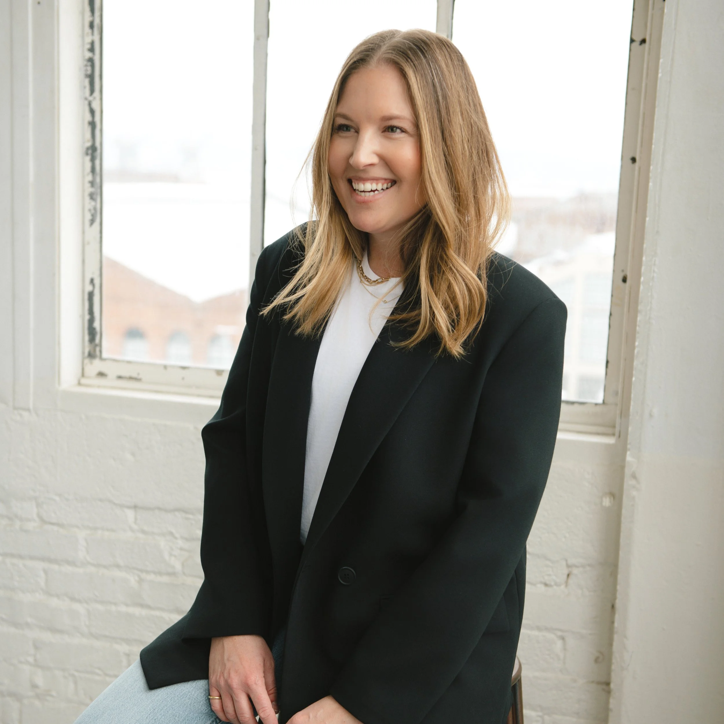 Bash Please team member photographed in a polished, editorial portrait setting.