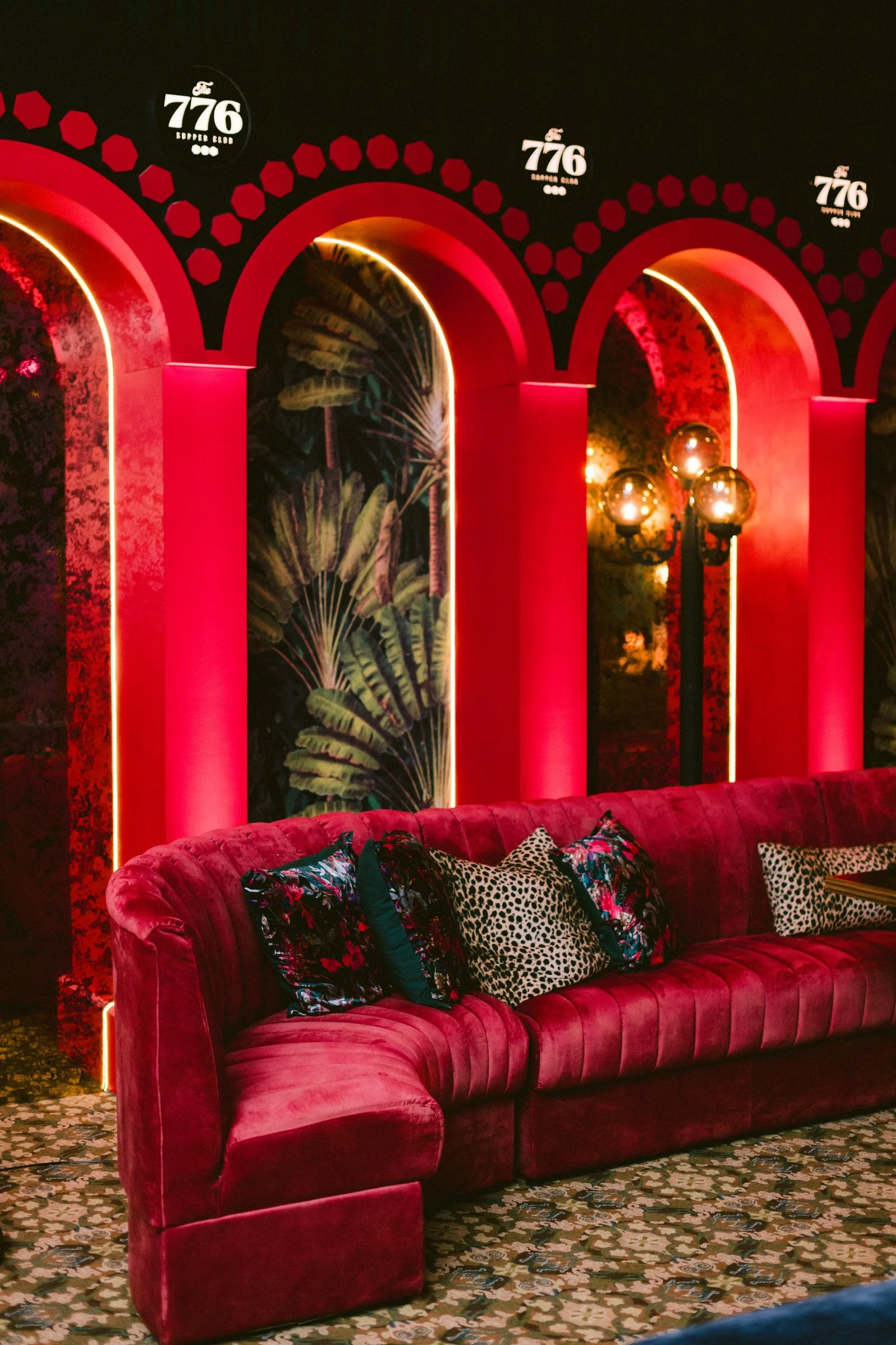 bash-please-utah-investor-community-summit-supper-club-red-velvet-banquette-illuminated-arches-tropical-wallpaper-corporate-event-design.jpg