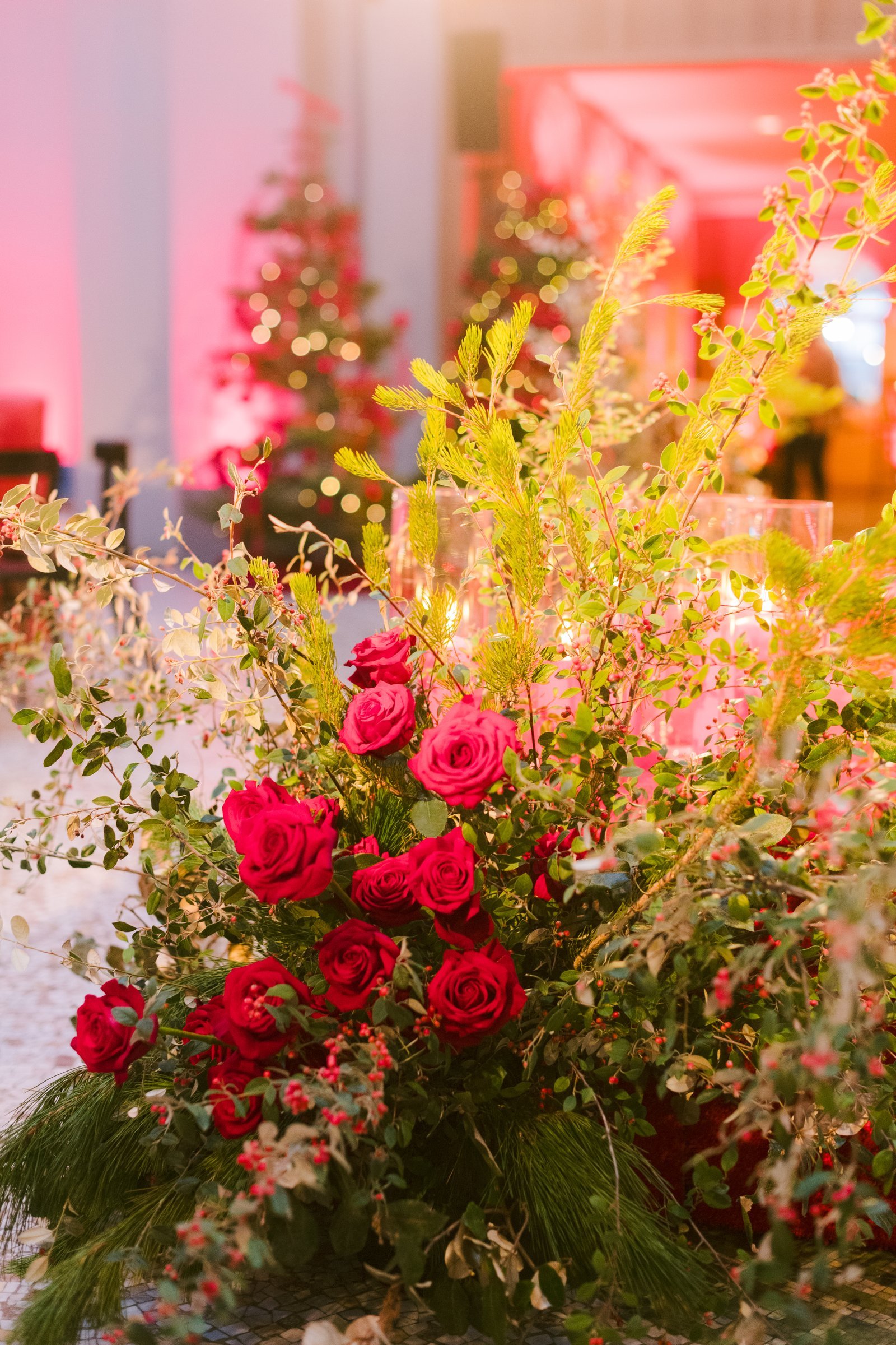 bay-area-corporate-holiday-party-red-rose-and-winter-greenery-floral-arrangement-holiday-party-san-francisco-twinkling-trees.jpg