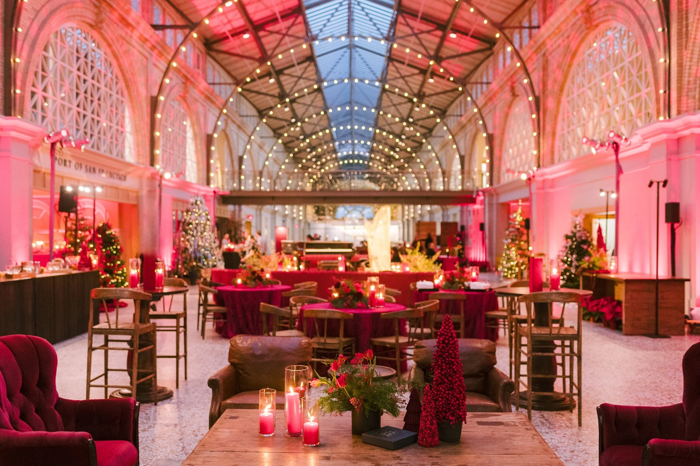 bay-area-corporate-holiday-party-san-francisco-ferry-building-great-hall-holiday-party-string-lights-pink-uplighting-red-velvet-lounge.jpg
