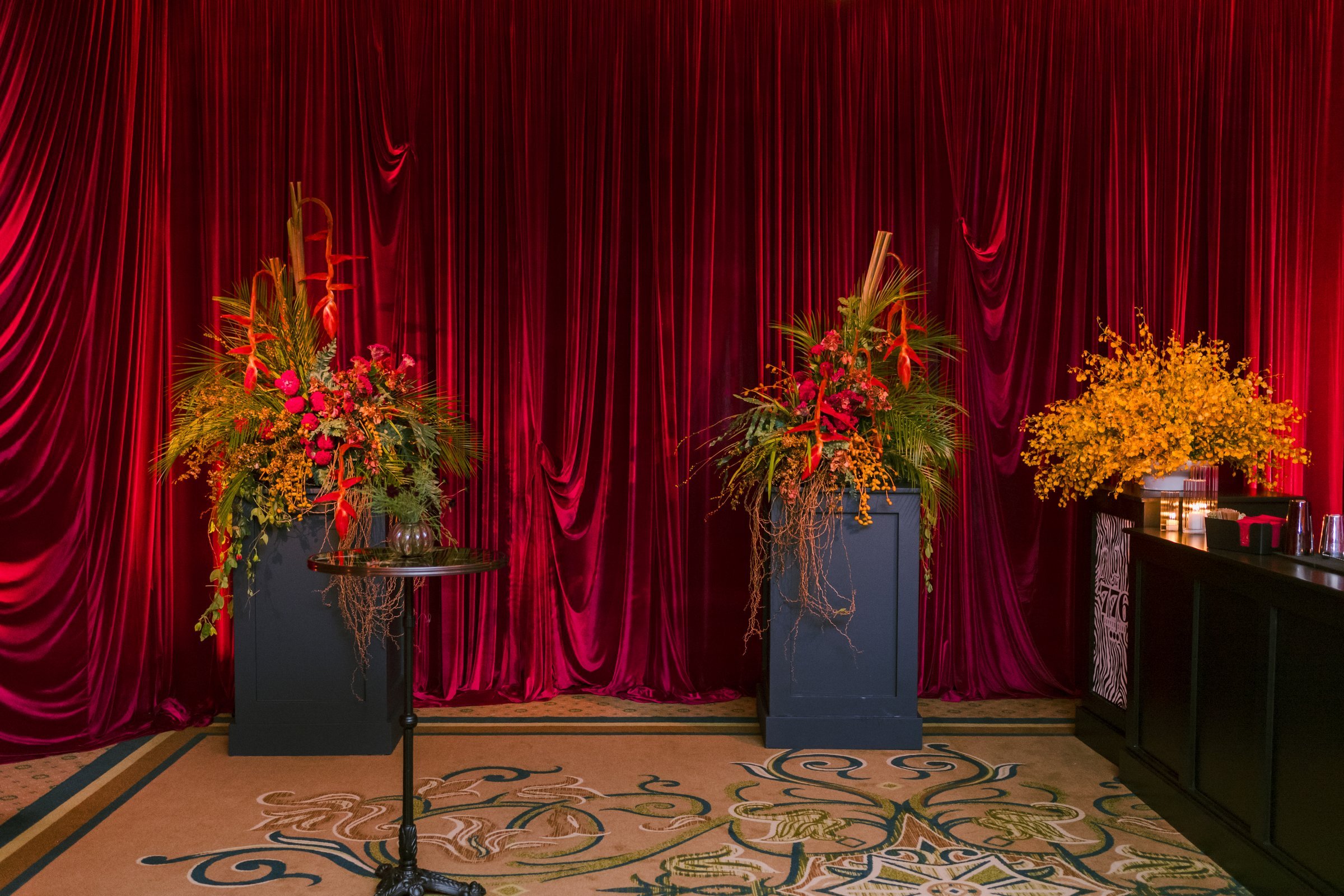 bash-please-utah-investor-community-summit-red-velvet-curtain-tropical-floral-arrangements-welcome-party-bar-corporate-event-design.jpg