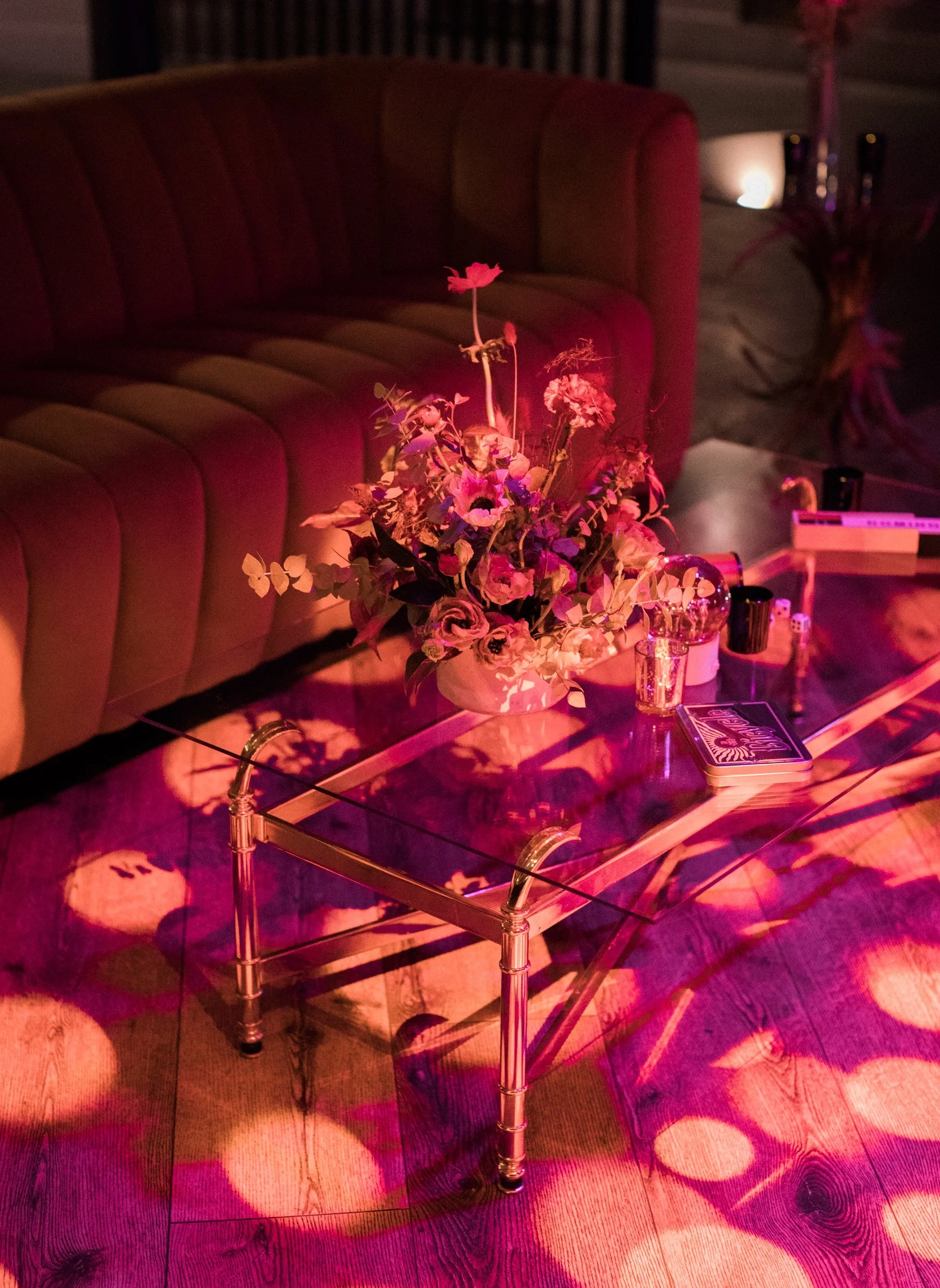 bay-area-corporate-holiday-party-holiday-lounge-channel-tufted-velvet-sofa-brass-coffee-table-wildflower-arrangement-gobo-lighting.jpg