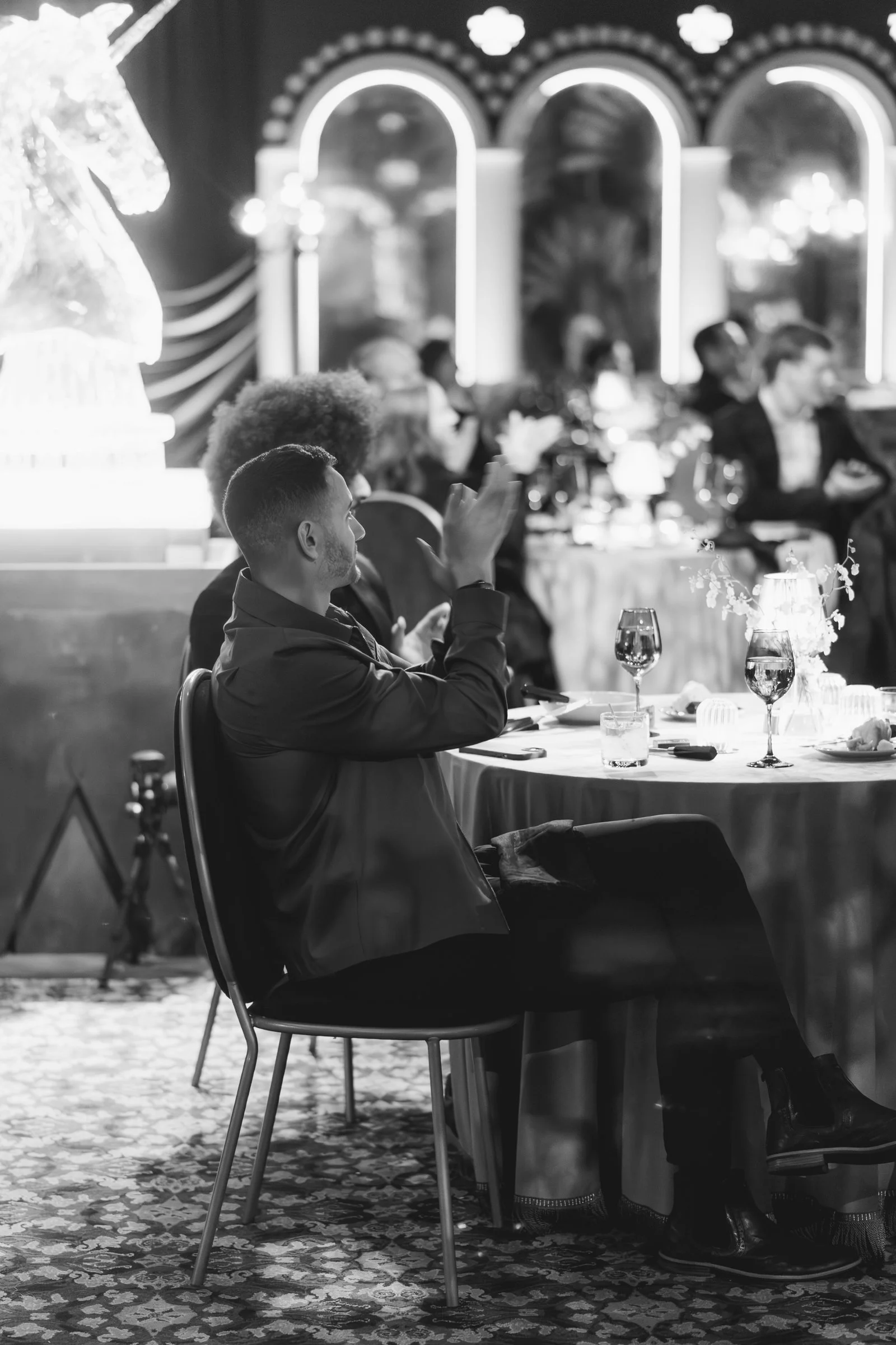 bash-please-utah-investor-community-summit-black-and-white-dinner-guests-applauding-ice-sculpture-supper-club-night.jpg