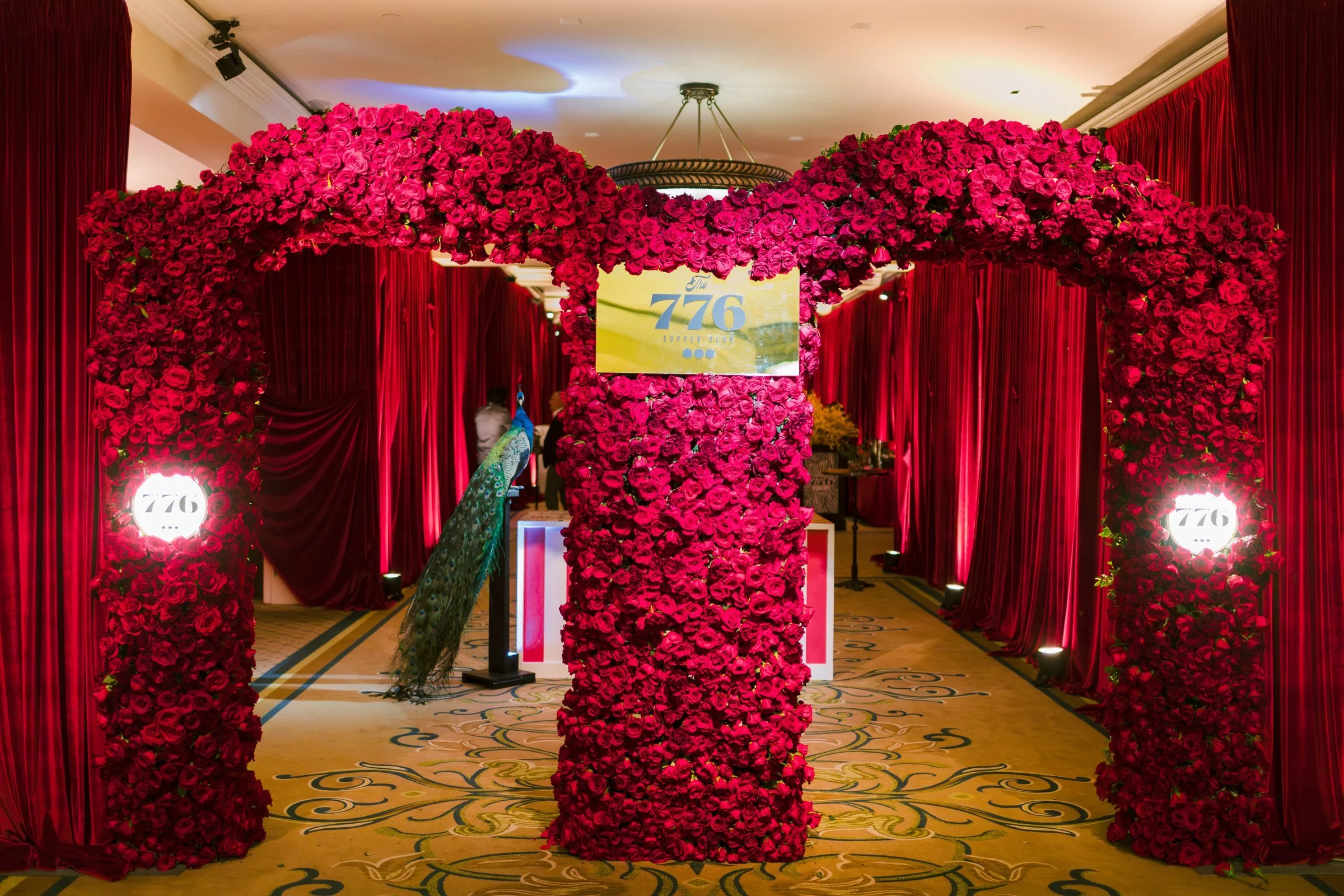 bash-please-utah-investor-community-summit-the-776-supper-club-rose-arch-entrance-red-velvet-drapery-luxury-corporate-event-design.jpg