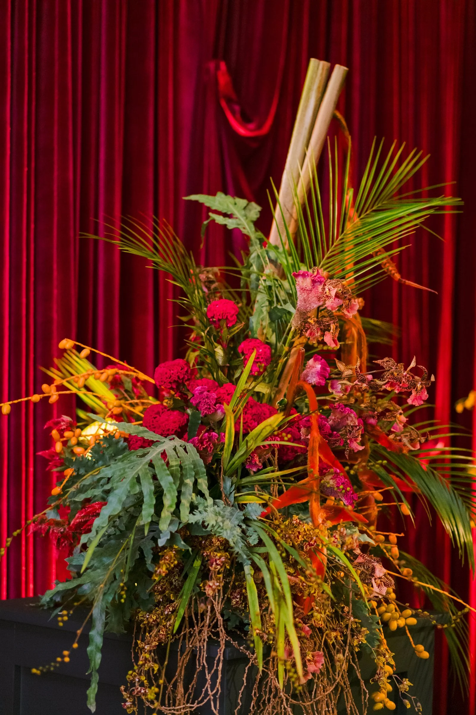 bash-please-utah-investor-community-summit-tropical-heliconia-celosia-orchid-floral-arrangement-red-velvet-curtain-welcome-party.jpg