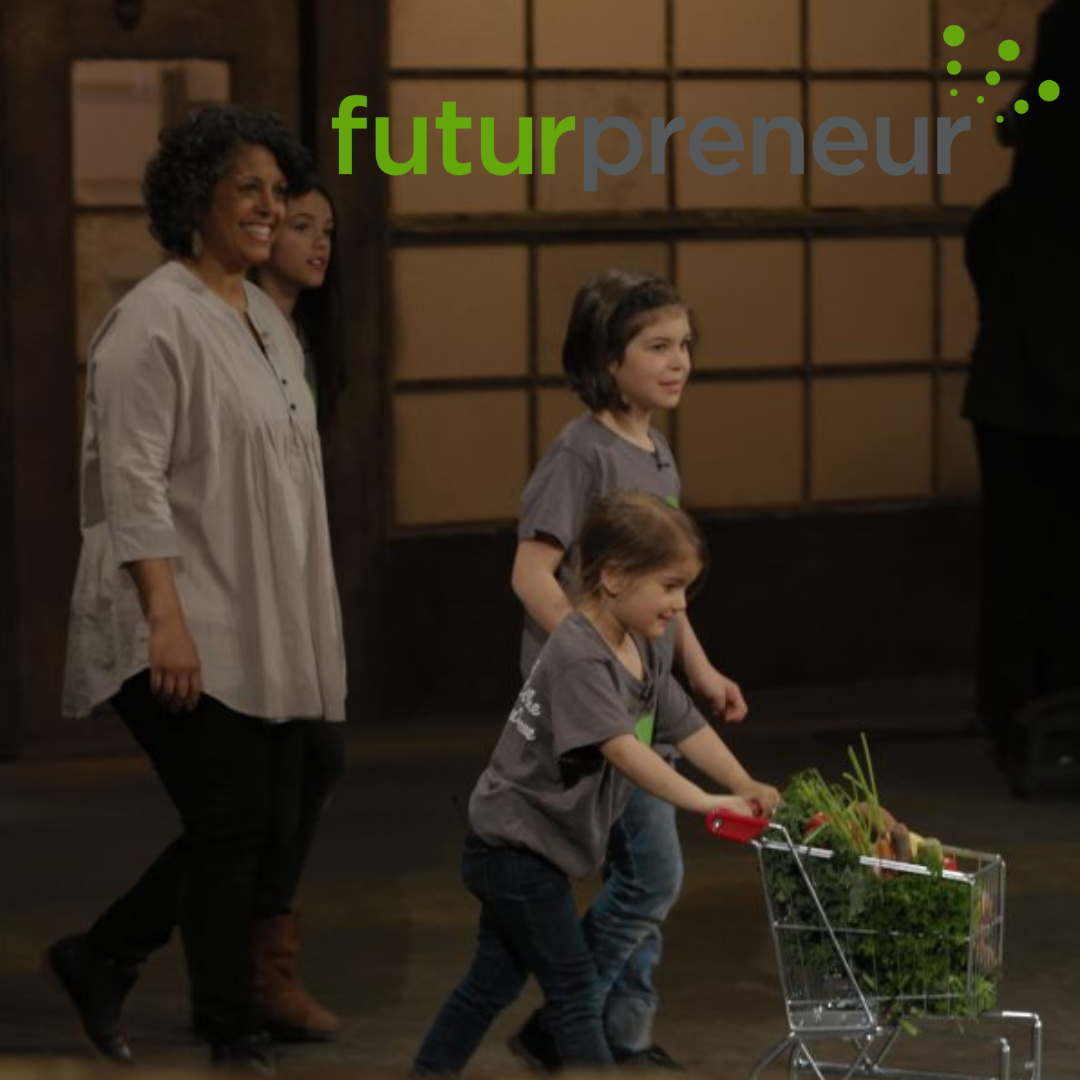 Three children pushing a shopping cart filled with vegetables in a room with wooden walls, accompanied by a smiling woman, with the logo 'futurpreneur' in the top right corner.