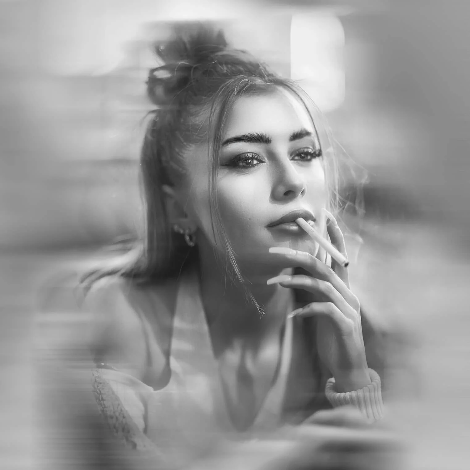 A black and white portrait of a woman with styled hair, wearing makeup and earrings, holding a cigarette near her lips, looking directly at the camera.