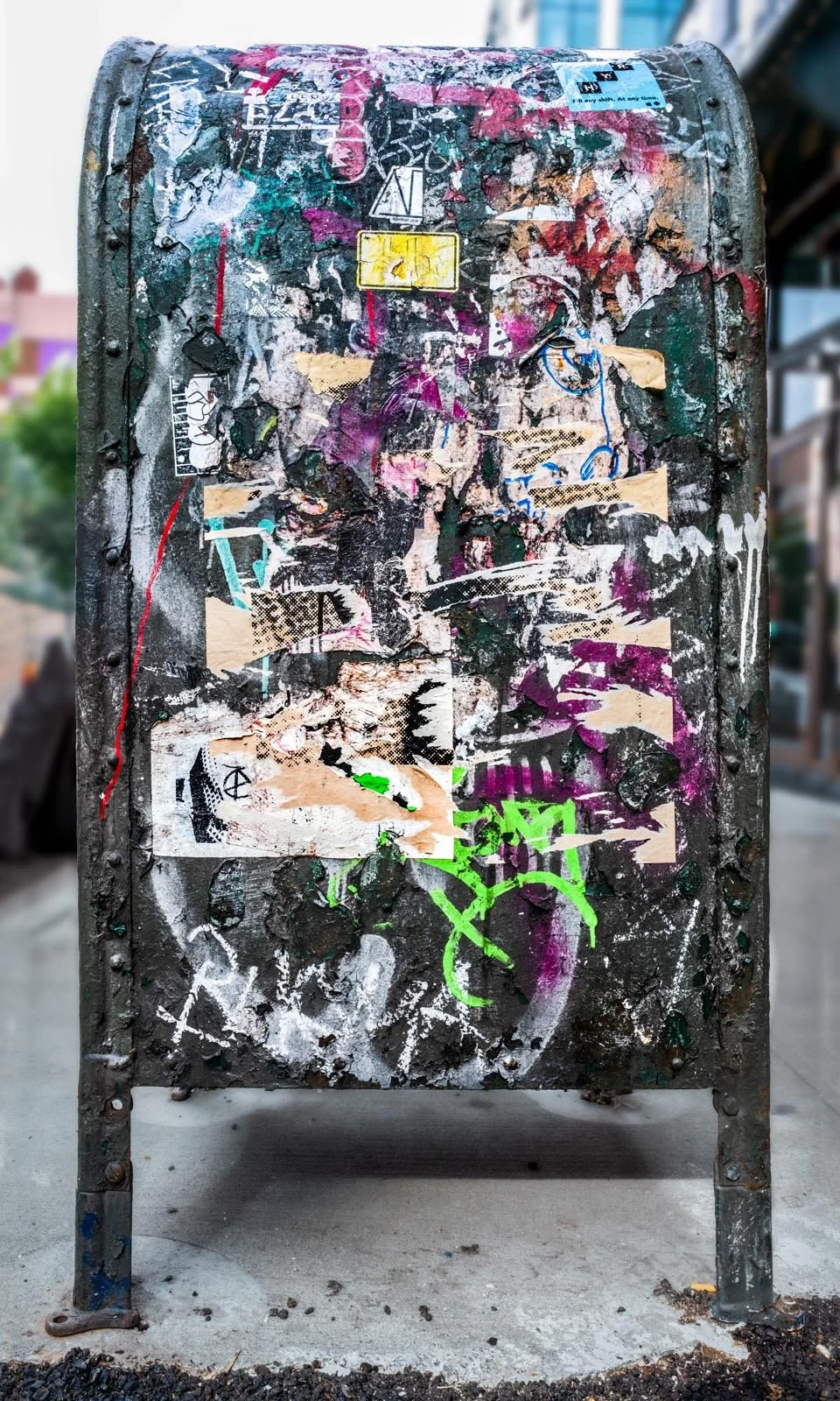Fine art urban photography print of a public New York City mailbox covered in sticker slaps and graffiti. This photograph of street art collage is captured by contemporary photographer Barton Lewis.