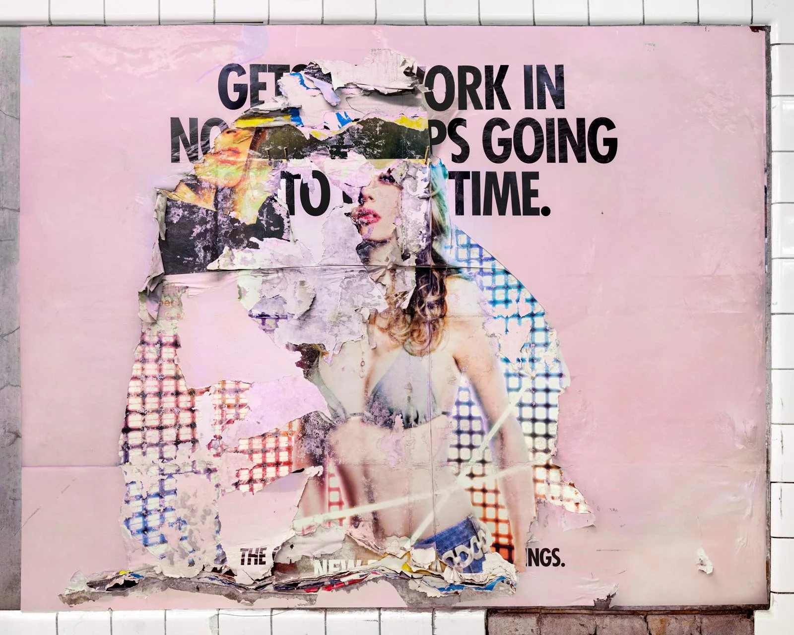 A photograph of a New York City subway advertising panel, containing posters torn by street artists and subway riders to create collage-like compositions.  Shot by Barton Lewis, capturing continuously mutating surfaces transformed into art by street 