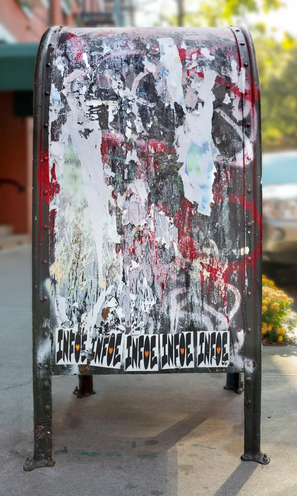 Fine art urban photography print of a public New York City mailbox covered in sticker slaps and graffiti. This photograph of street art collage is captured by contemporary photographer Barton Lewis.