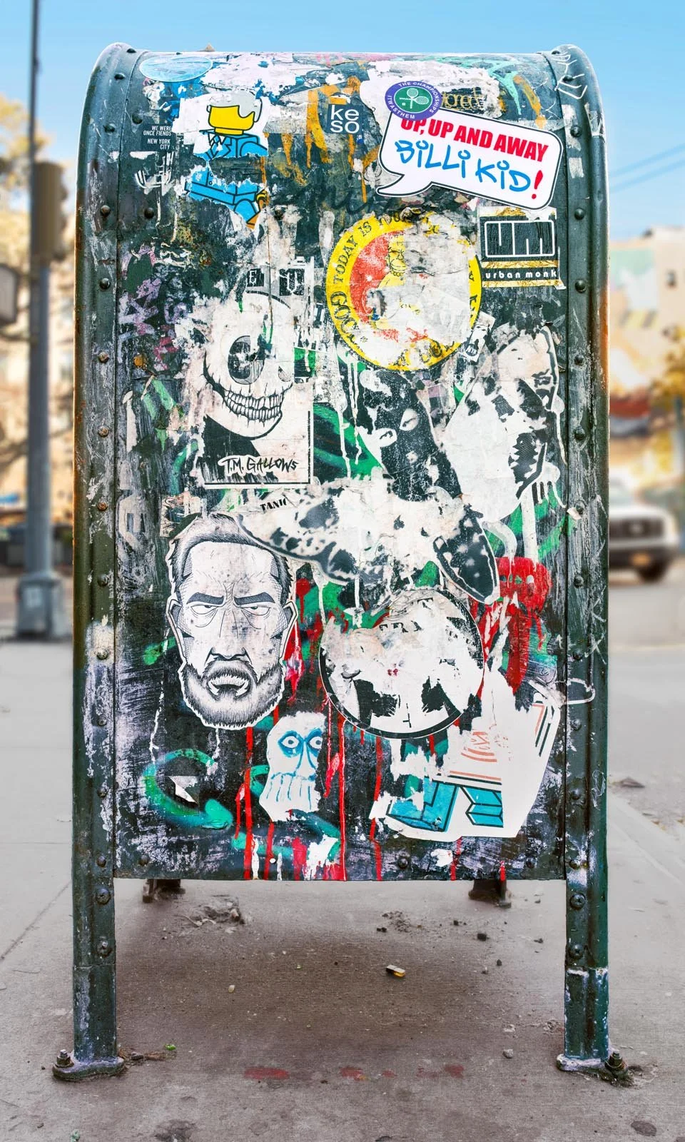 Fine art urban photography print of a public New York City mailbox covered in sticker slaps and graffiti. This photograph of street art collage is captured by contemporary photographer Barton Lewis.