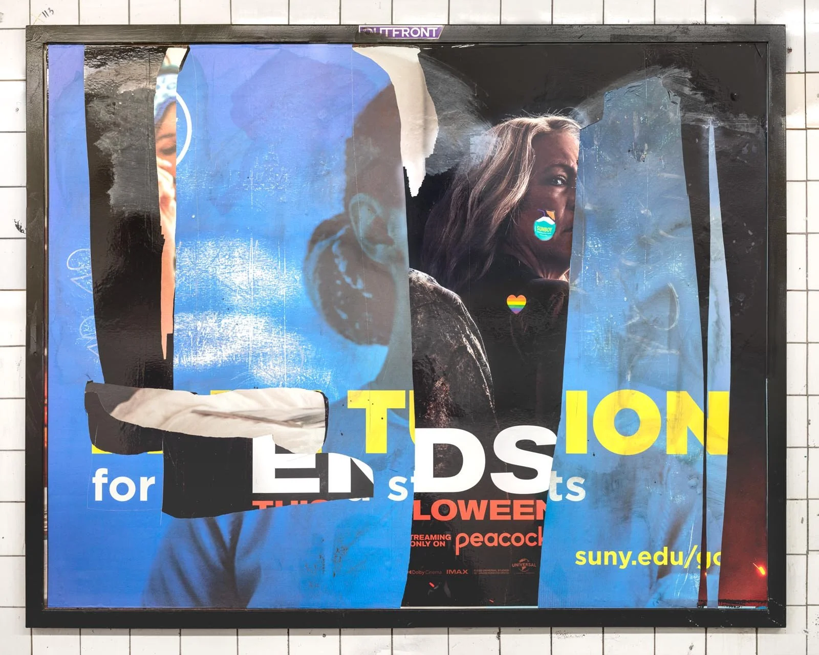 A photograph of a New York City subway advertising panel, containing posters torn by street artists and subway riders to create collage-like compositions.  Shot by Barton Lewis, capturing continuously mutating surfaces transformed into art by street 