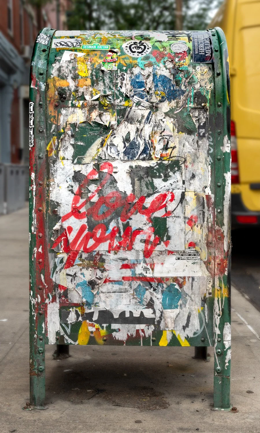 Fine art urban photography print of a public New York City mailbox covered in sticker slaps and graffiti. This photograph of street art collage is captured by contemporary photographer Barton Lewis.
