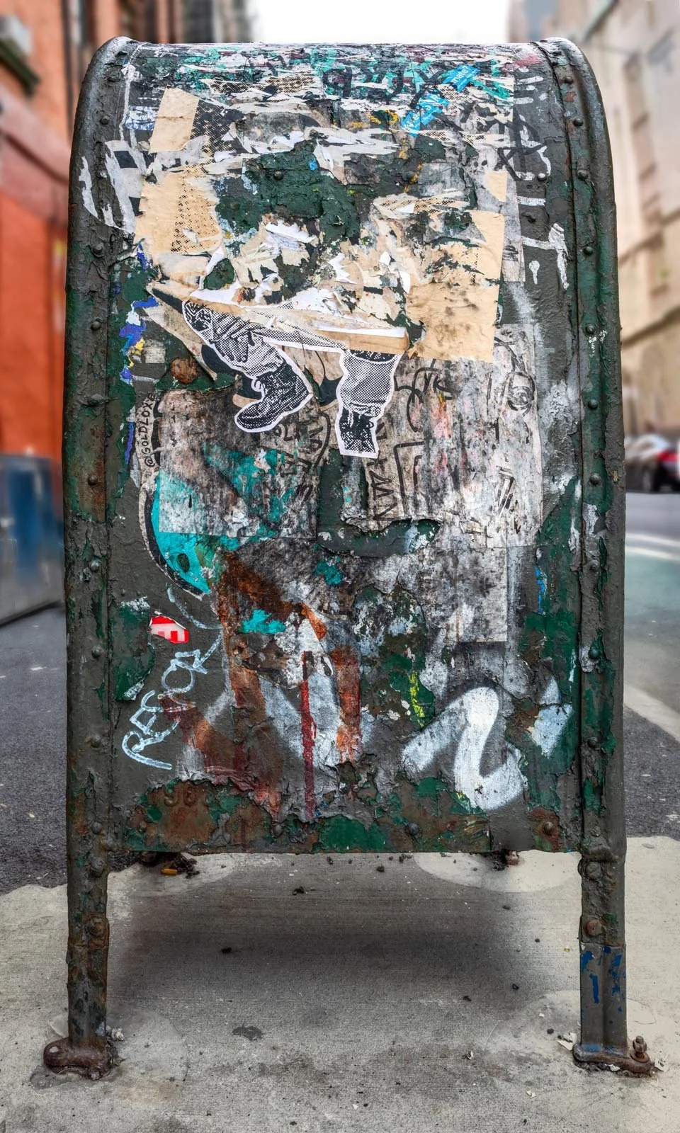 Fine art urban photography print of a public New York City mailbox covered in sticker slaps and graffiti. This photograph of street art collage is captured by contemporary photographer Barton Lewis.